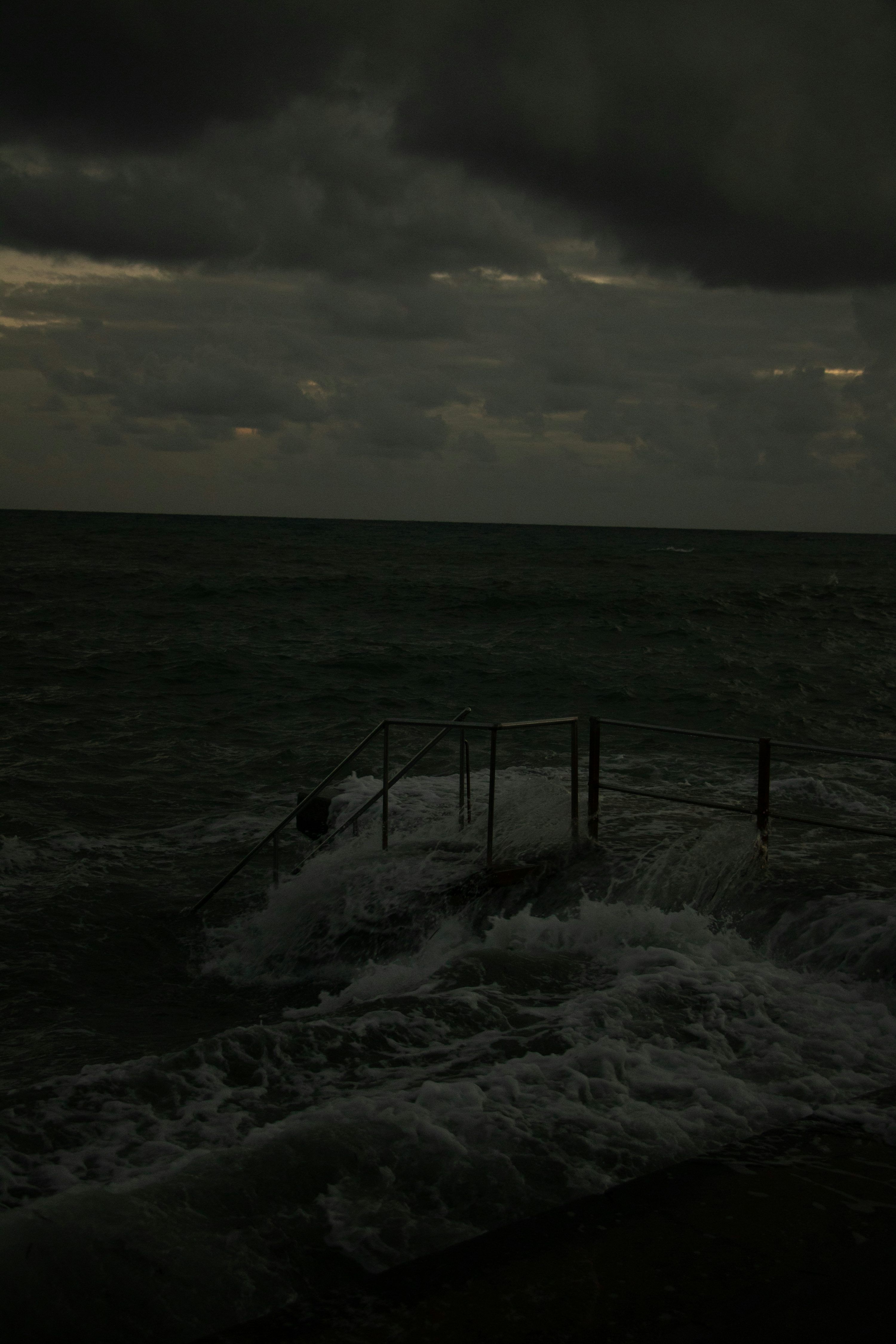 3000x4500 A dark stormy sky over the ocean with waves photo