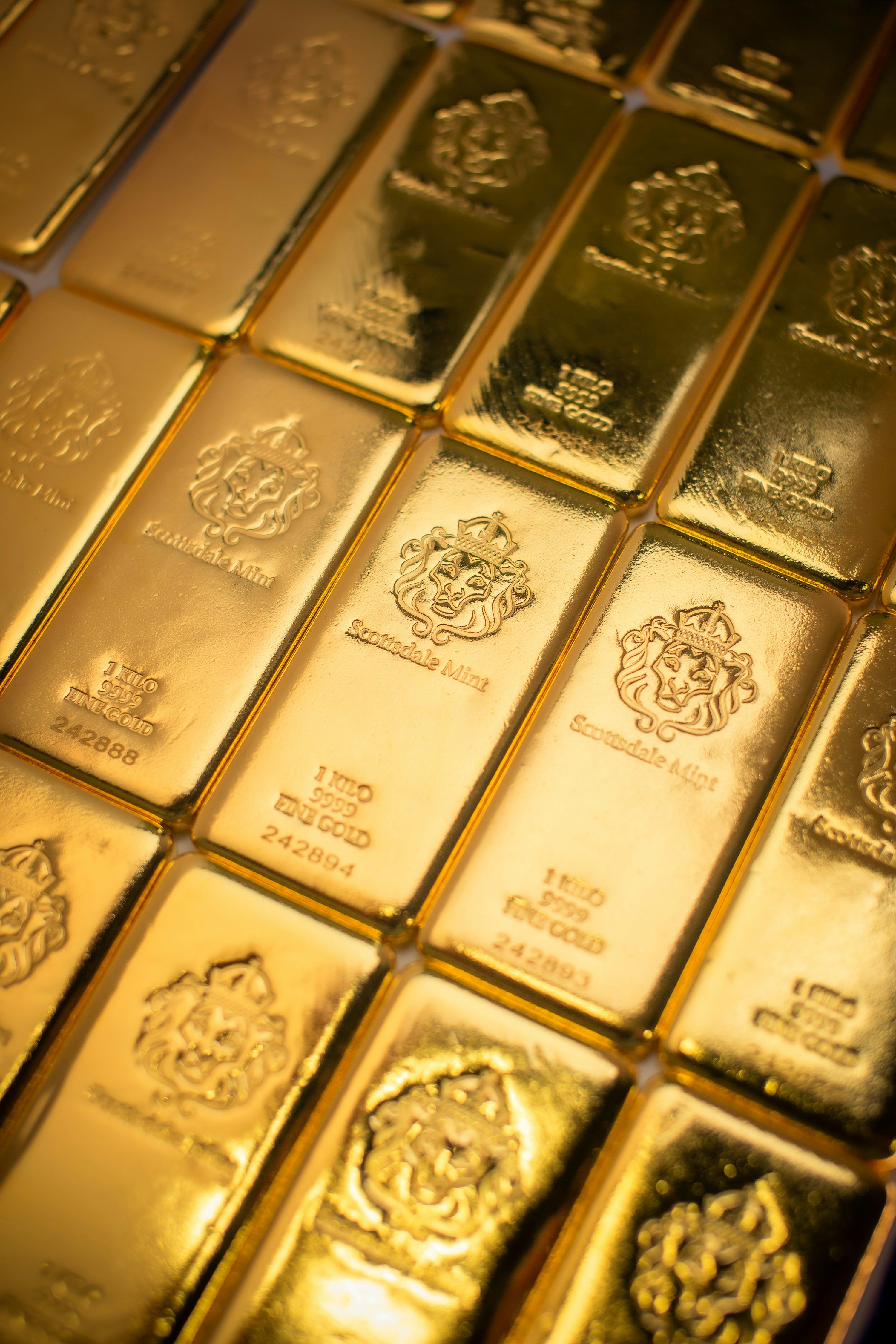 3000x4500 A pile of gold bars sitting on top of a table photo