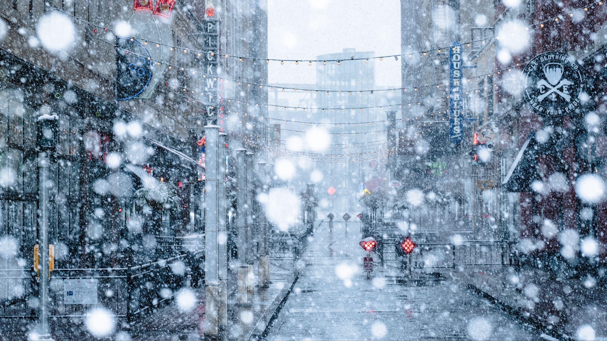 2560x1440 Download wallpaper 2560x1440 snowfall, snow, street, city, winter