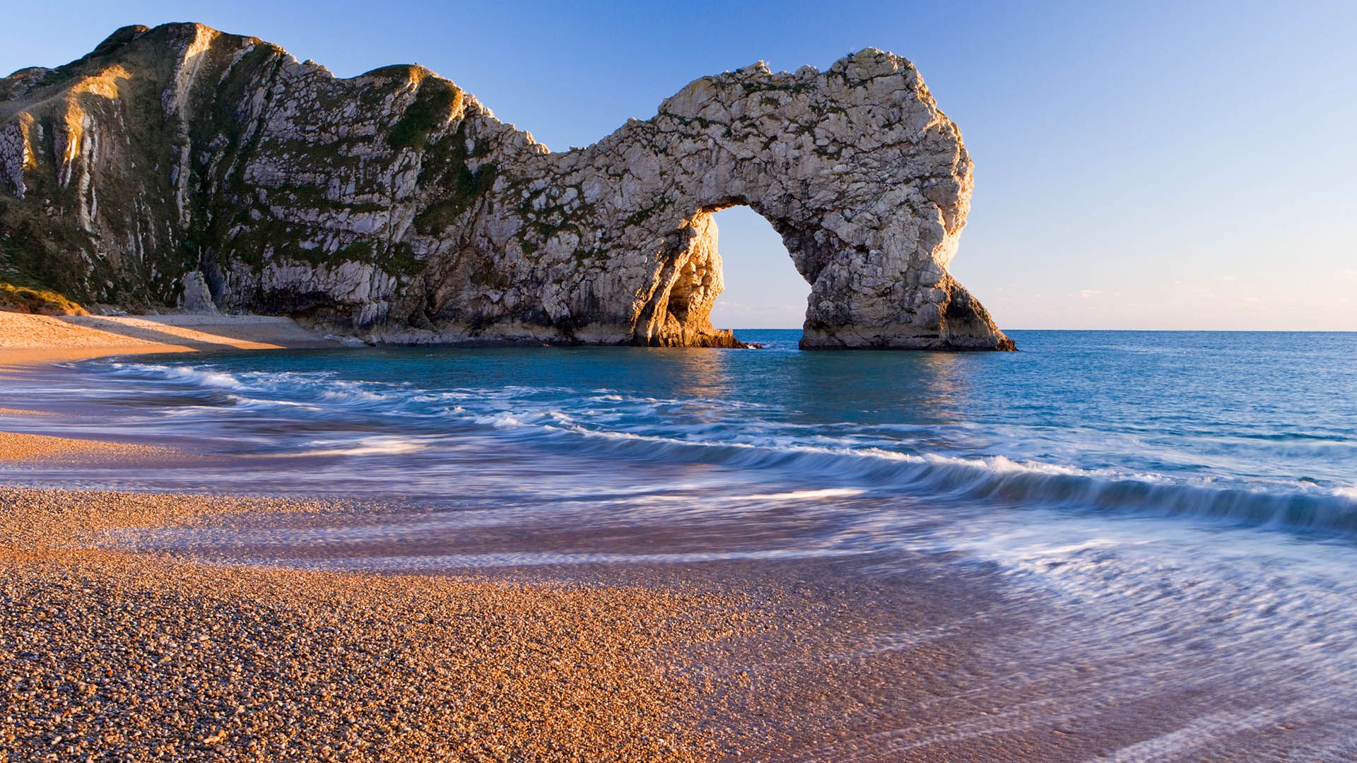 1920x1080 Durdle Door natural limestone arch on the Jurassic Coast near Lulworth, Dorset, England, UK. Windows Spotlight Image