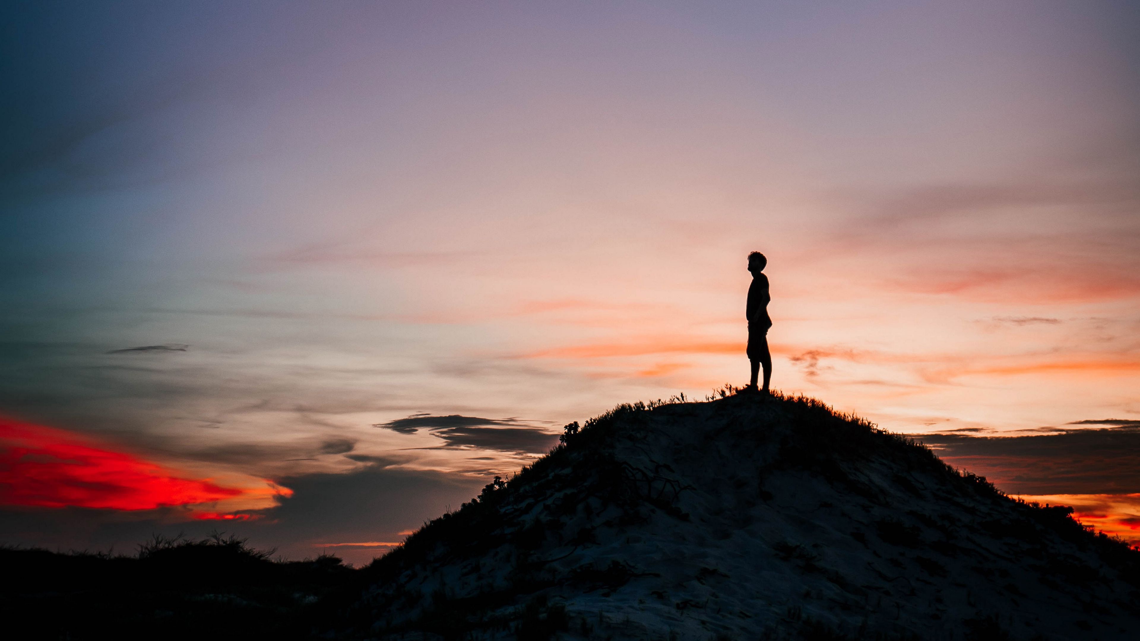 3840x2160 Man Is Standing Alone On Rock Sand In Silhouette Background 4K HD Alone Wallpaper