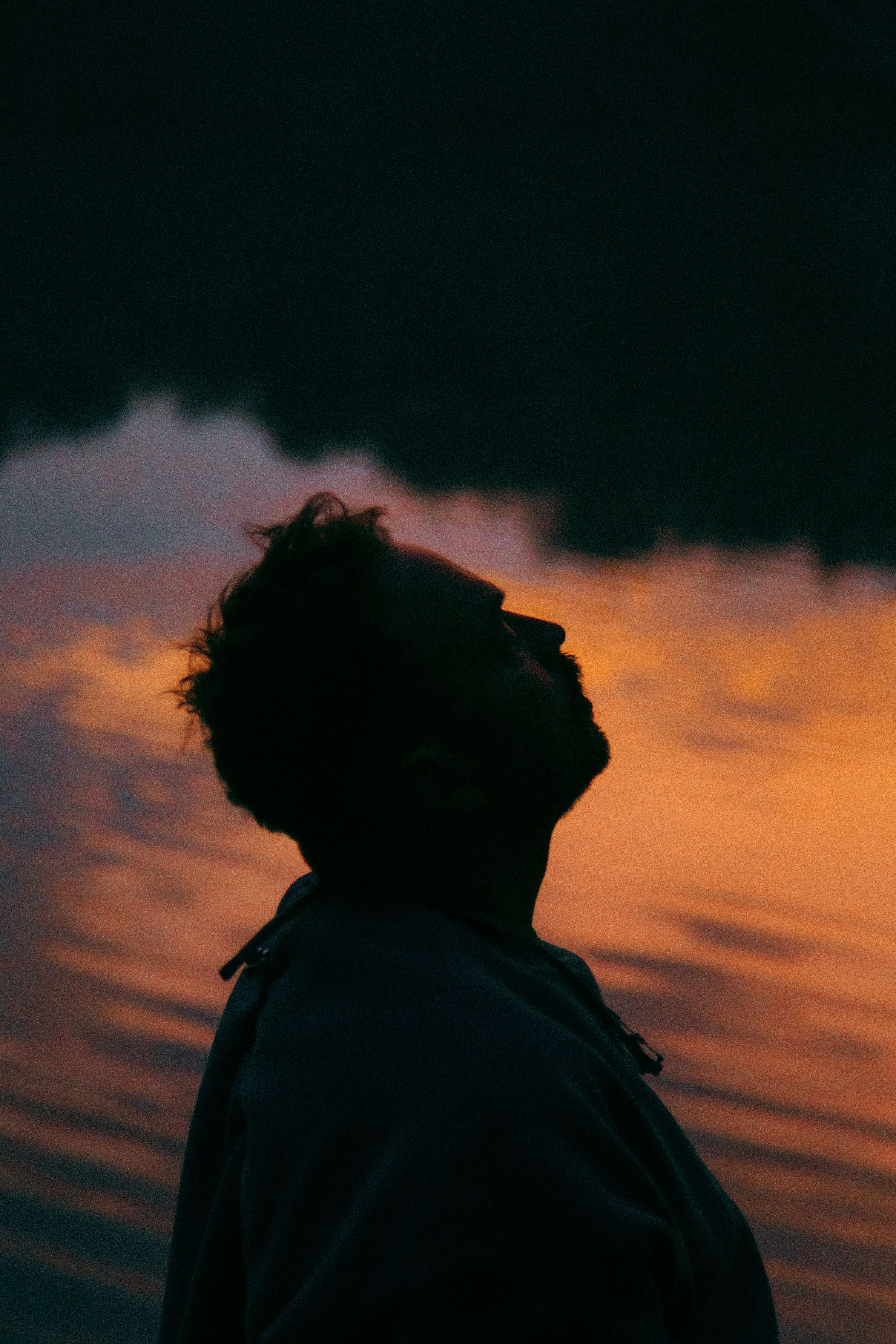 3000x4500 Silhouette of a person looking up at the sky photo