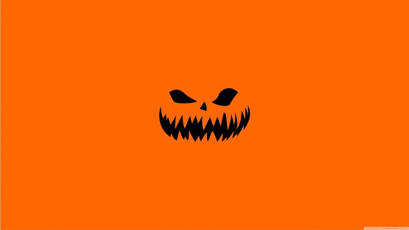 1366x768 Scary Halloween Face on Orange Background Wallpaper