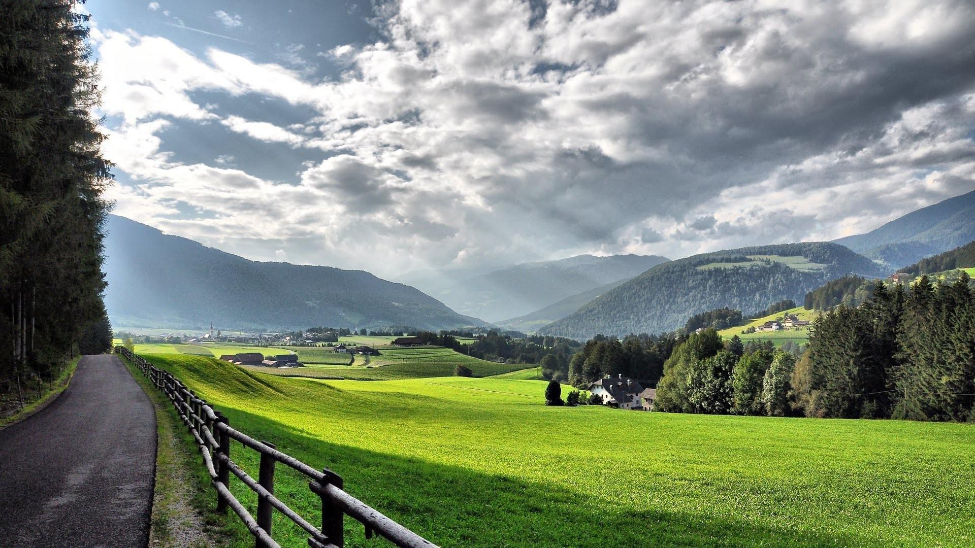 1920x1080 Country Road Thru A Beautiful Alpine Valley In Summer wallpaper
