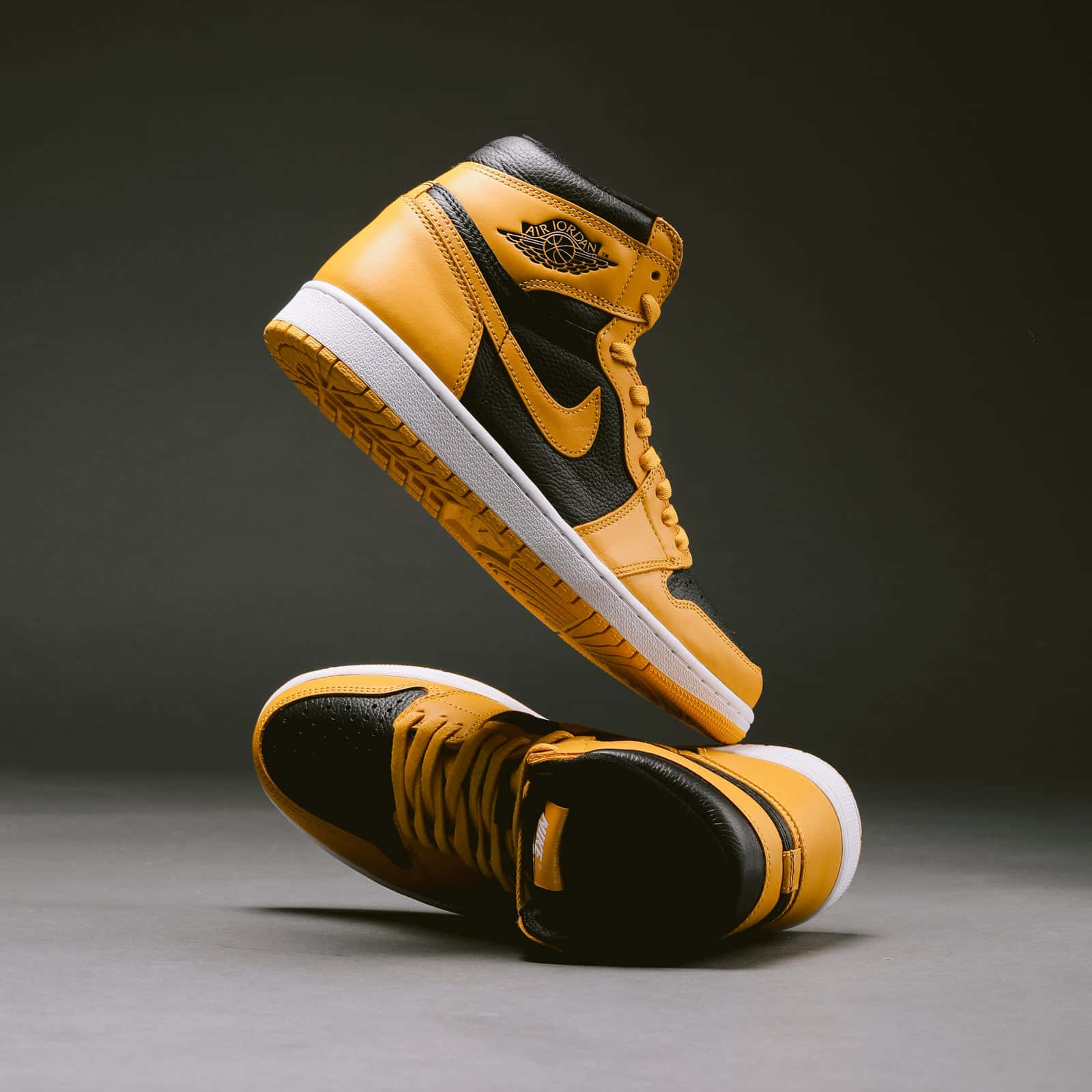 1600x1600 Download Look stylish and bold in the classic Yellow Jordan sneaker. Wallpaper