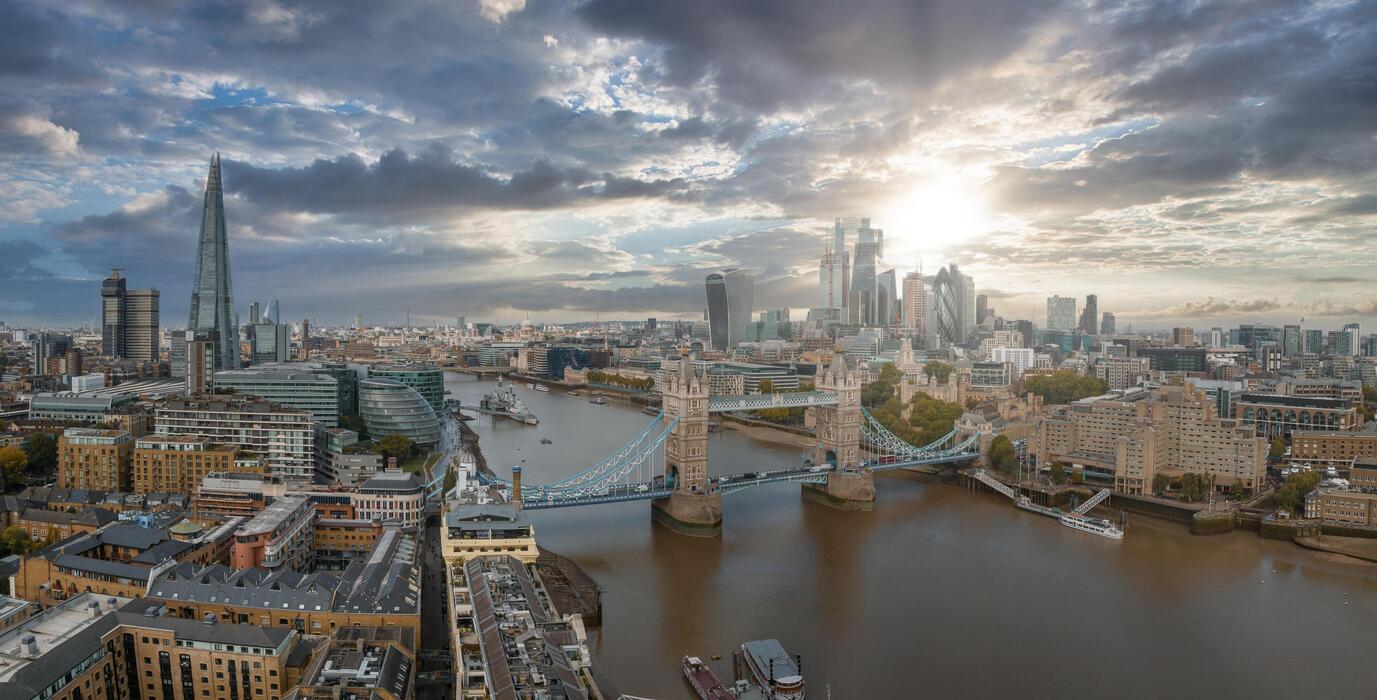 1377x700 Aerial view of the Tower bridge, central London, from the South bank of the Thames