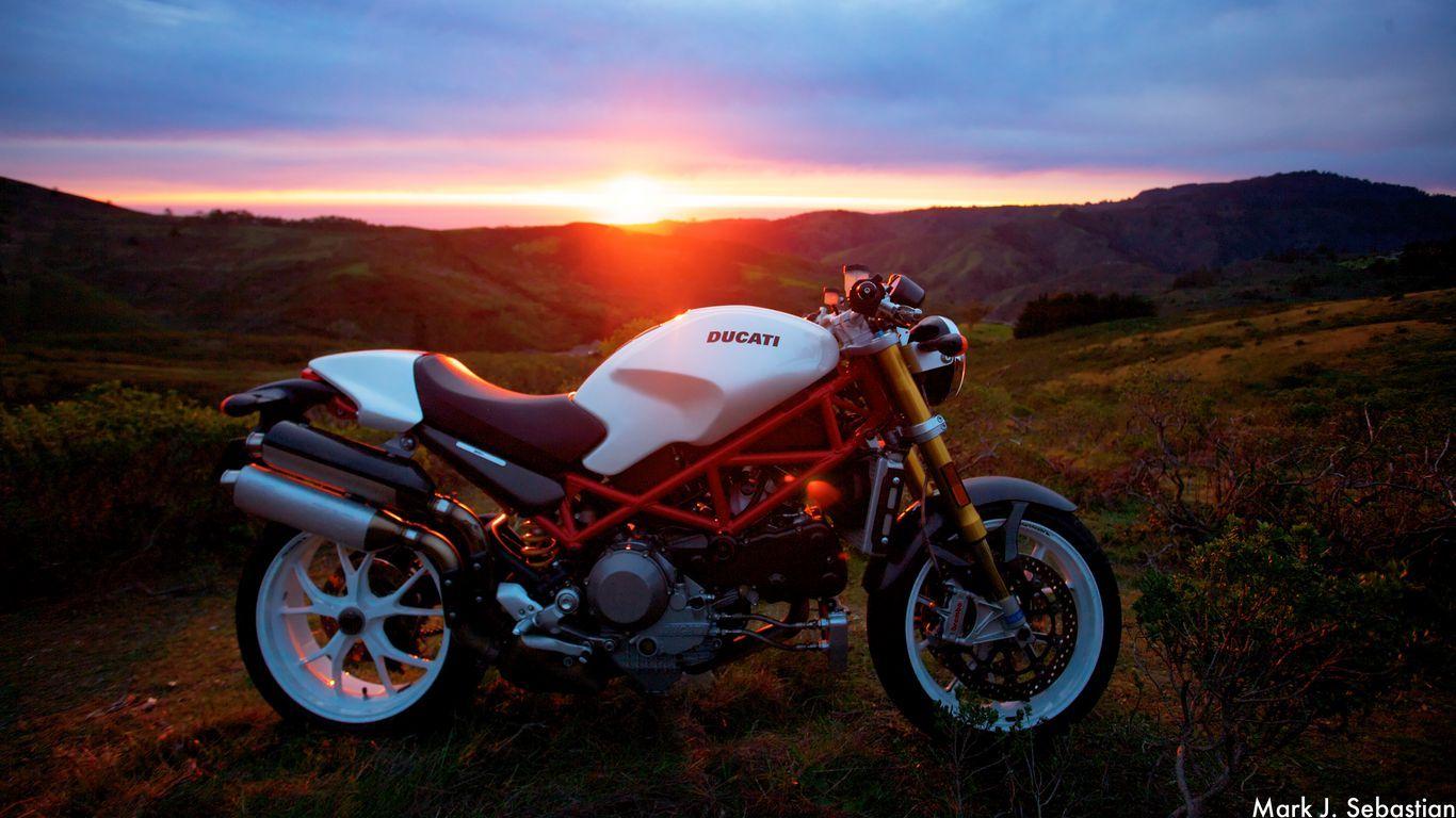 1366x768 Download wallpaper 1366x768 motorcycle, ducati, sunlight, sunset