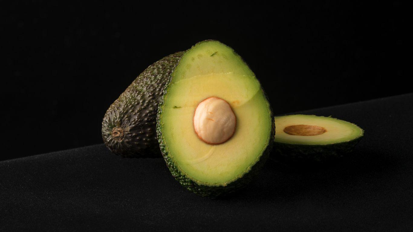 1366x768 Download wallpaper 1366x768 avocado, ossicle, fruit, slicing