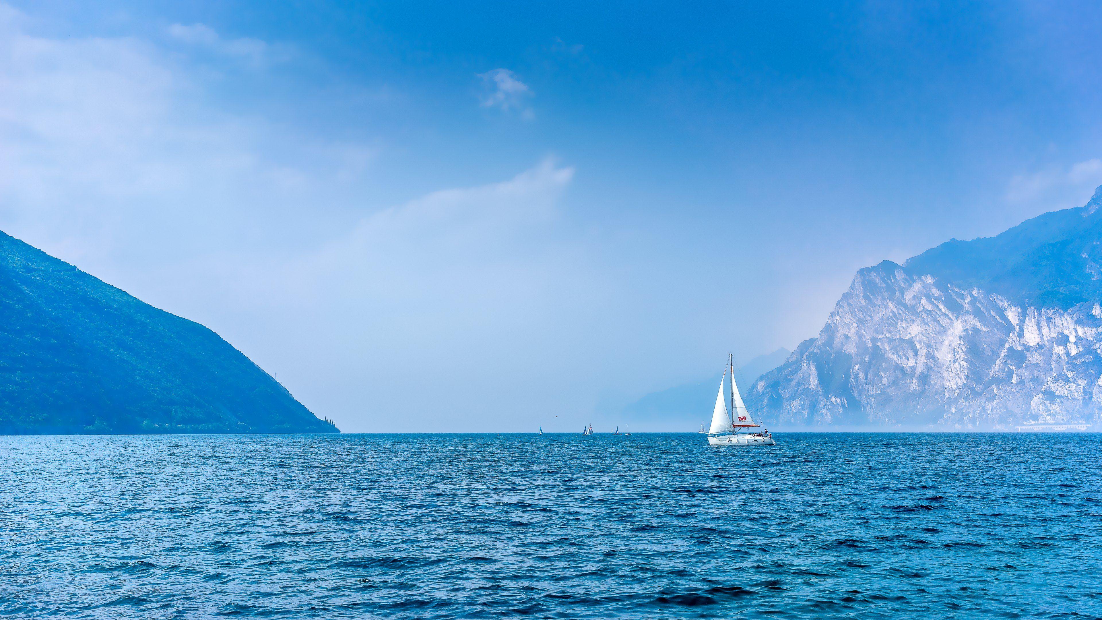 3840x2160 Serene Horizon: 4K Ultra HD Sailboat on Blue Ocean