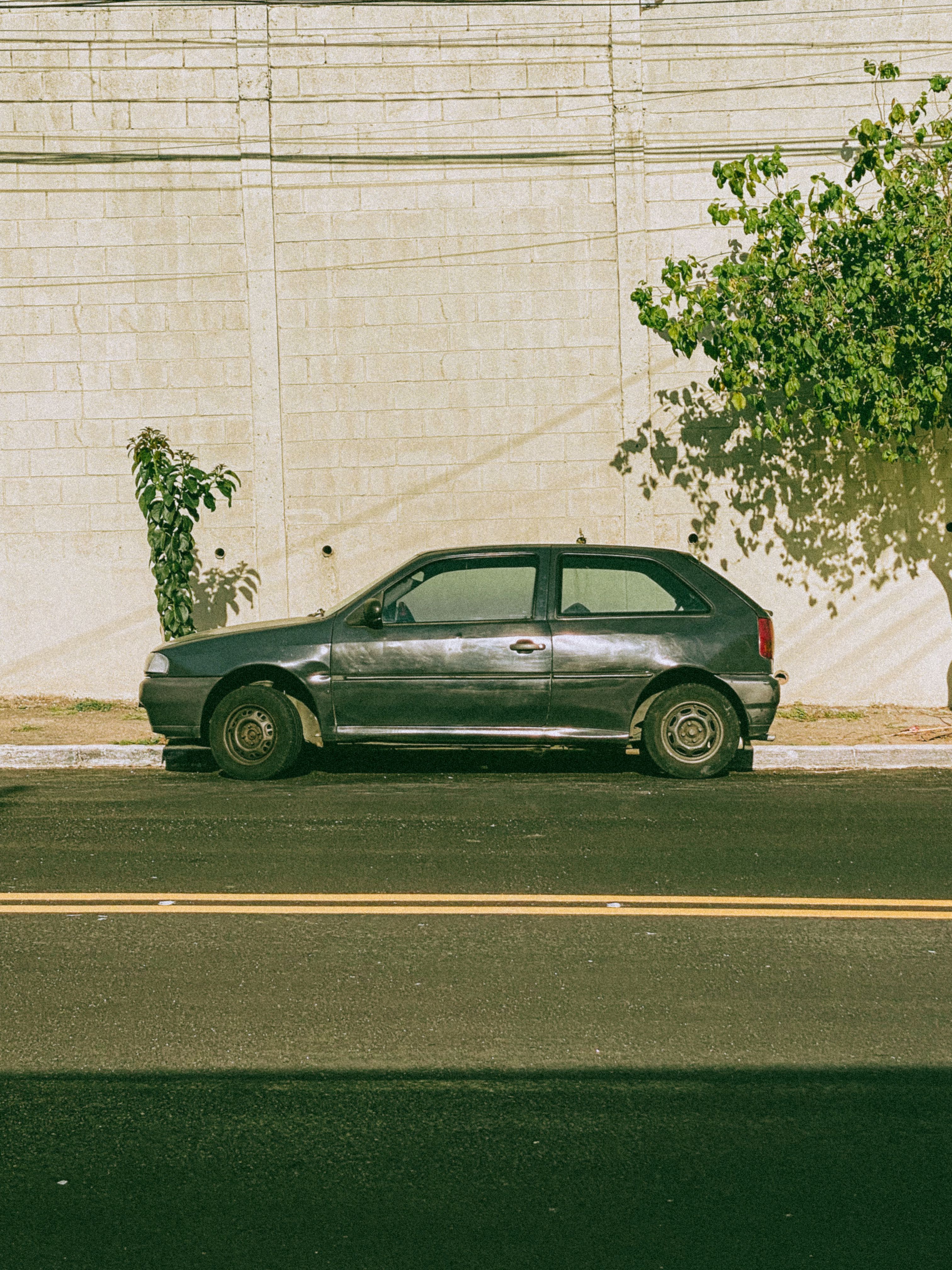 3024x4032 A Volkswagen Golf II with a Cover Parked by the Wall · Free