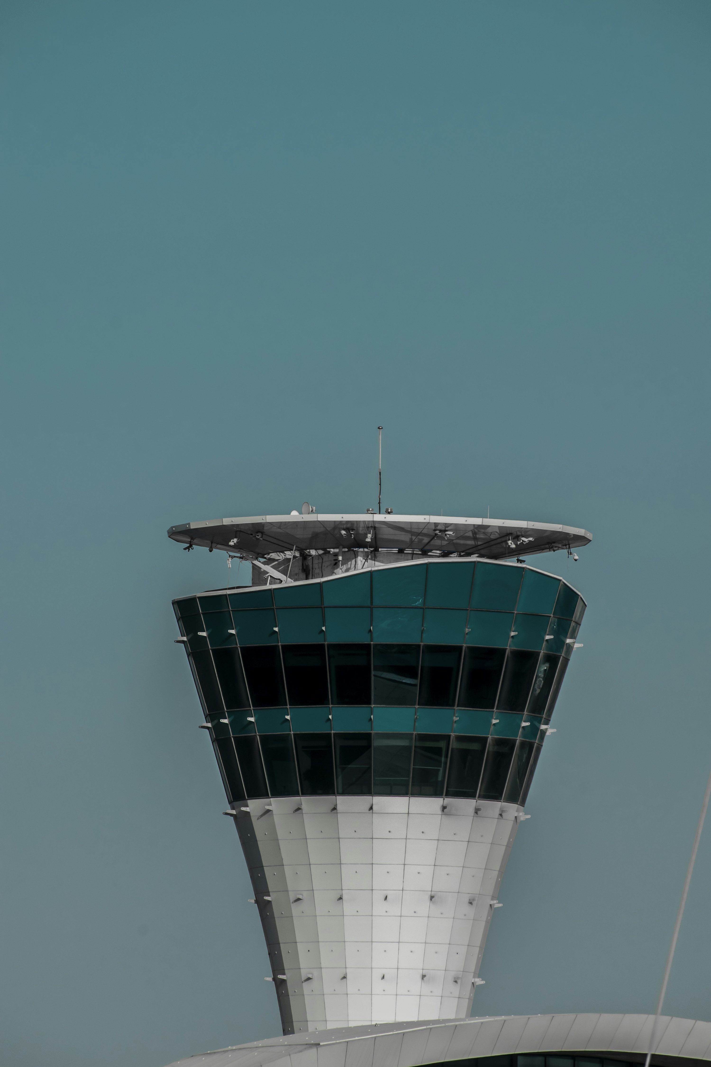 3000x4500 Airport control tower against a clear, blue sky. photo