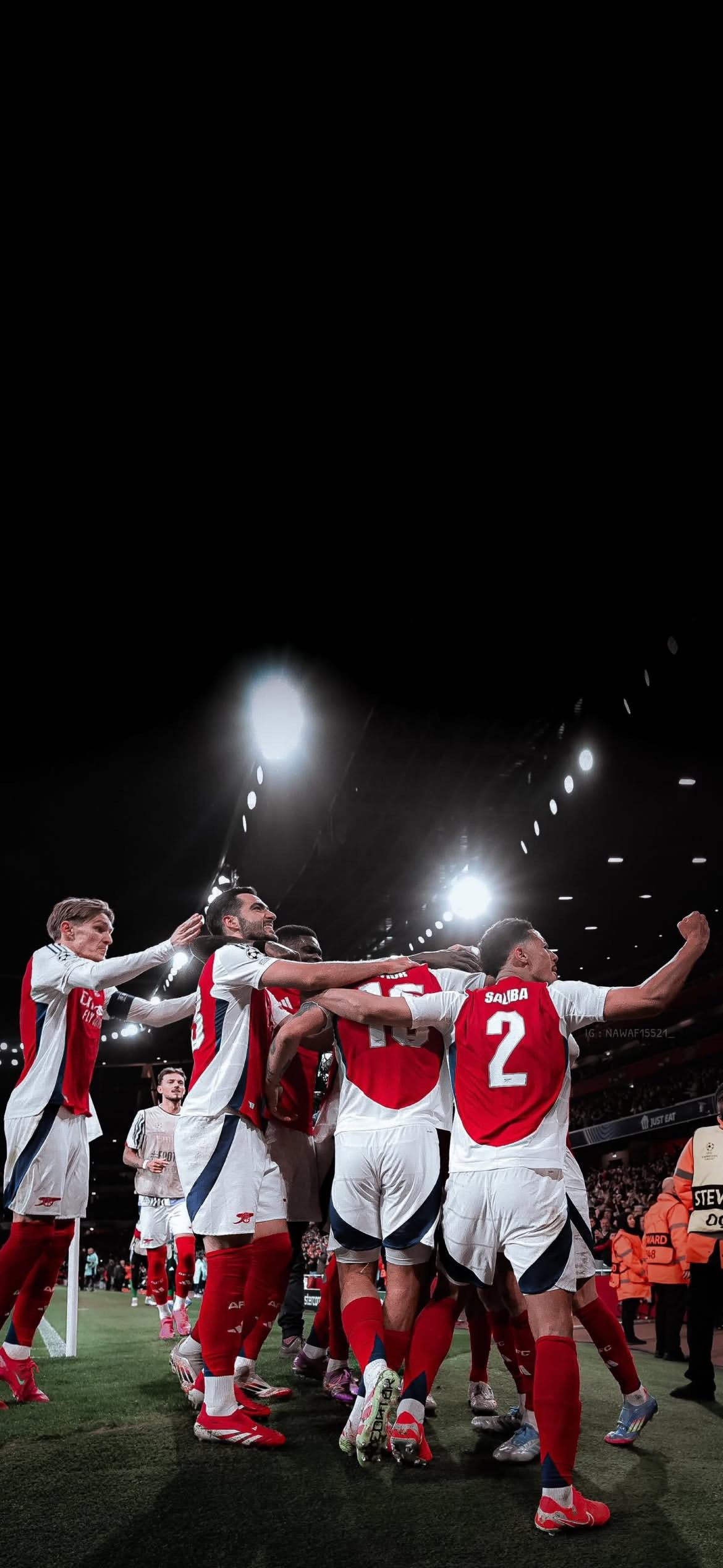 1170x2536 Arsenal players celebrate a Champions League match Football Wallpaper