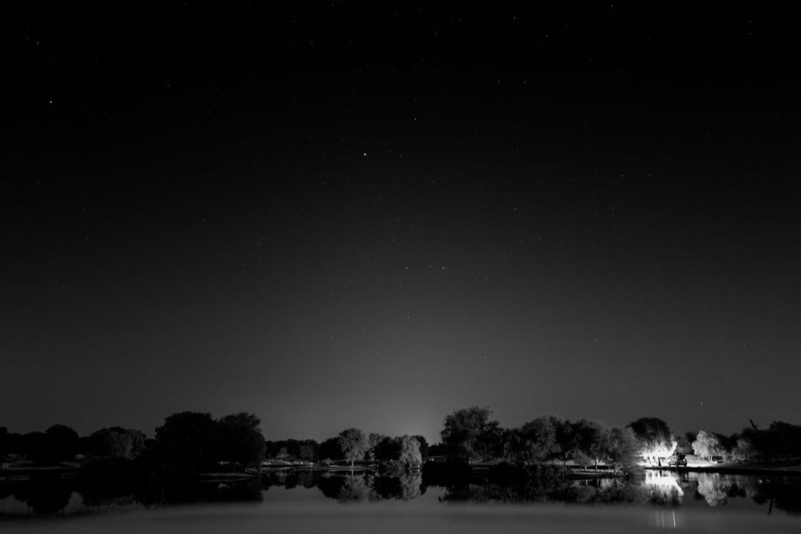 1124x750 Black and White Starry Night Over Dubai Landscape · Free