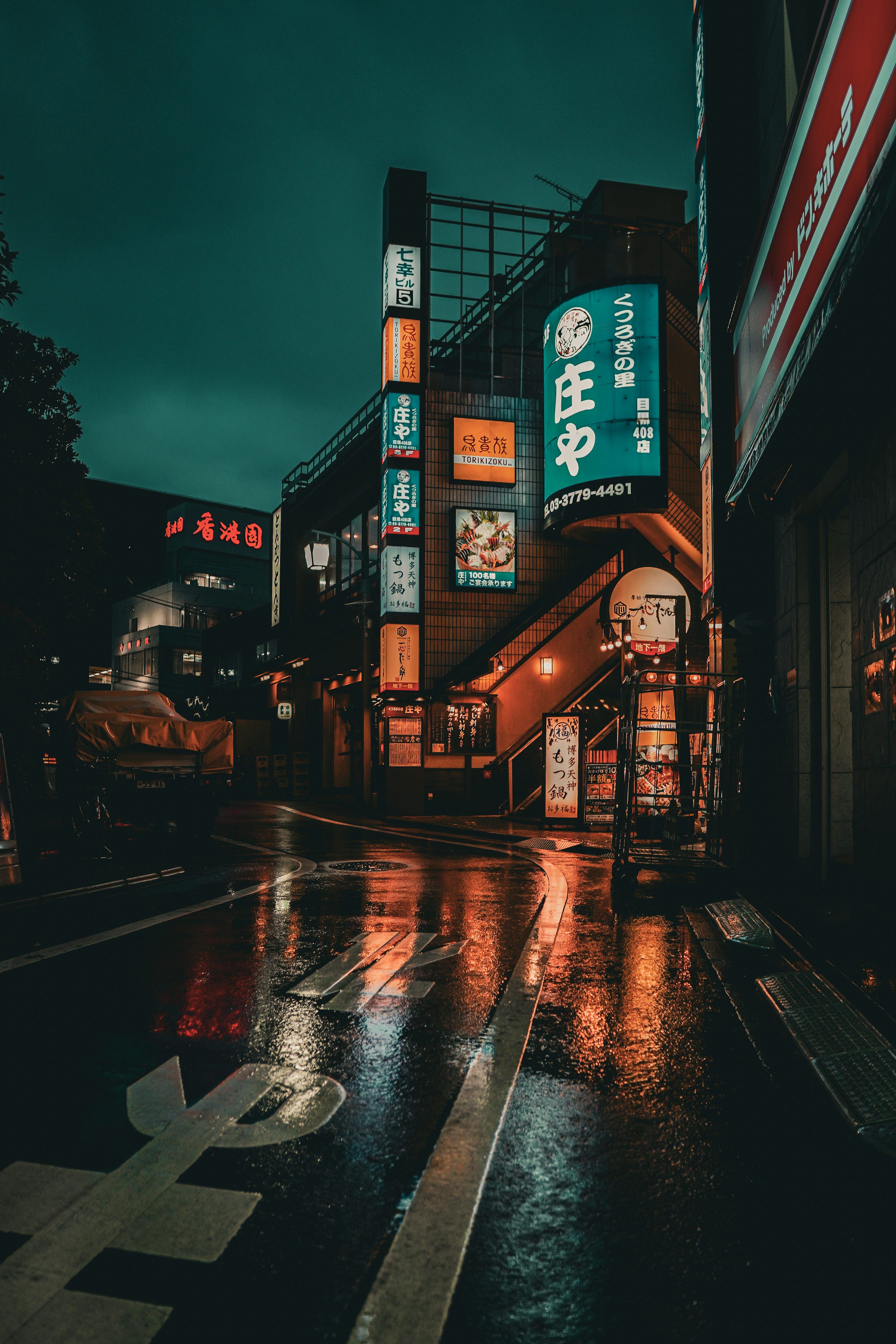 3000x4500 Nighttime street scene in japan with neon signs. photo