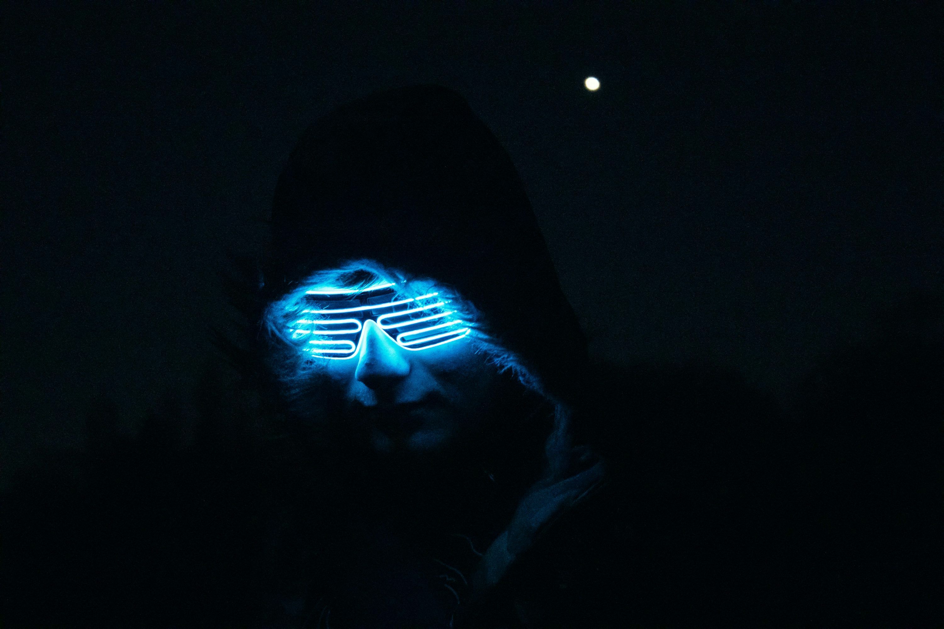 3000x2000 A man wearing a glowing mask in the dark photo