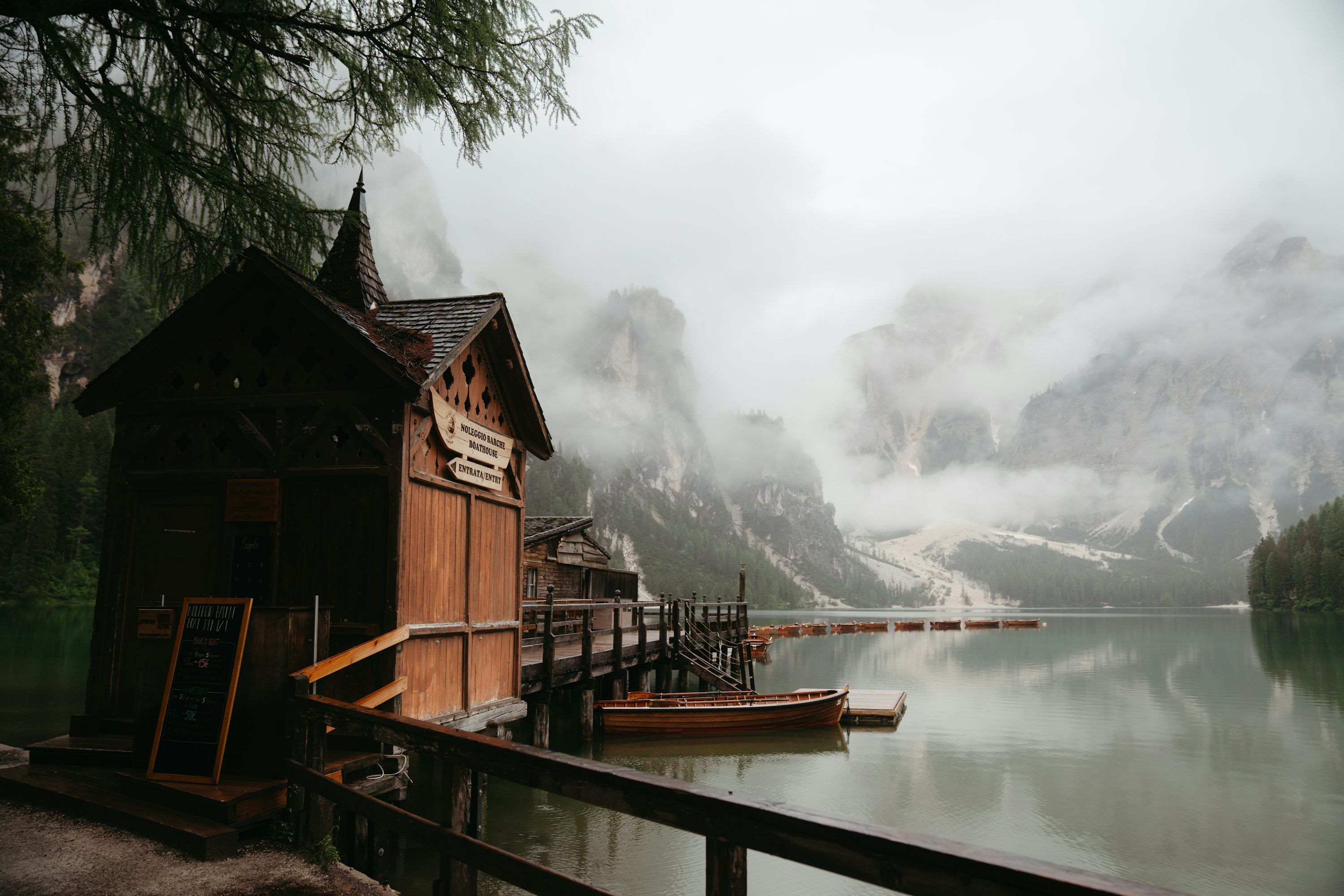 3000x2000 A boat dock on a lake with mountains in the background photo