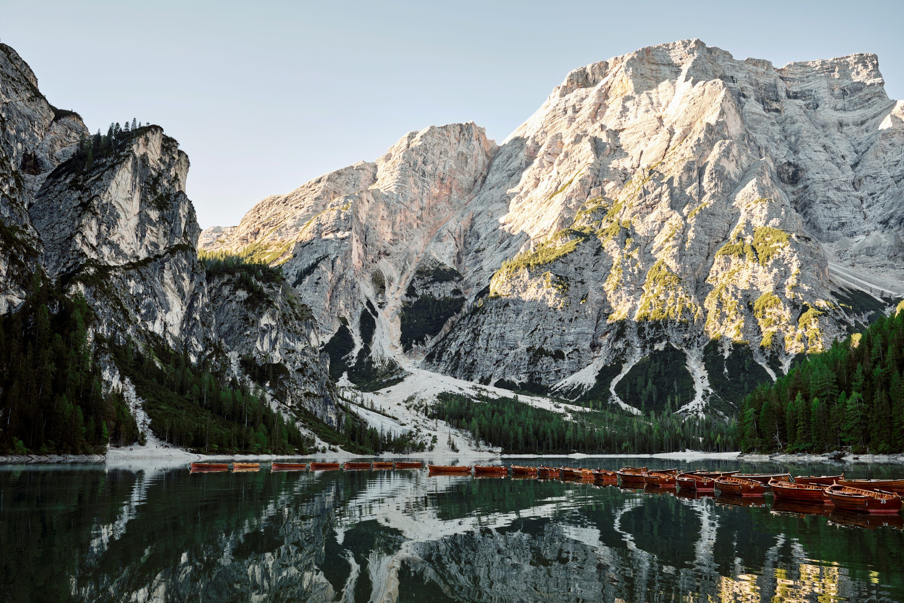 3000x2000 A mountain range is reflected in the still water of a lake photo
