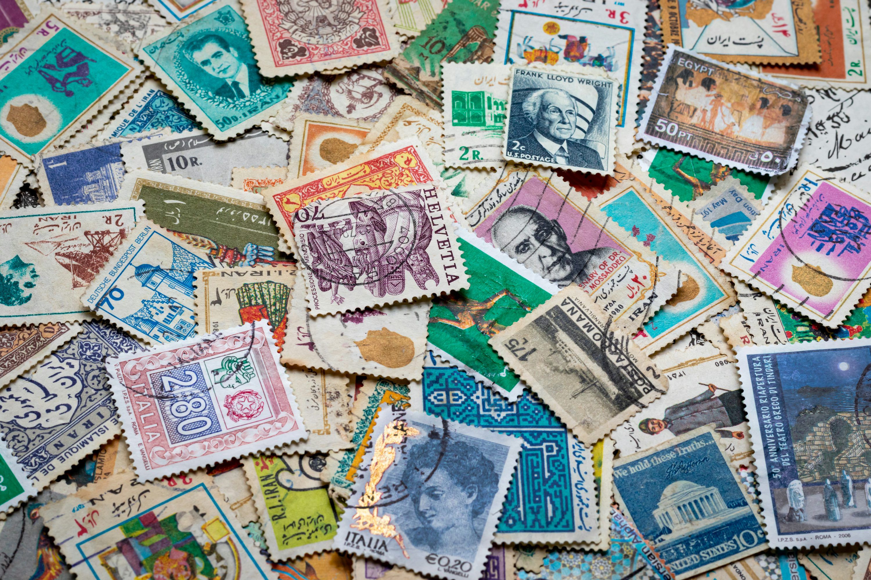 3000x2000 Assorted postage stamps on blue and white textile photo