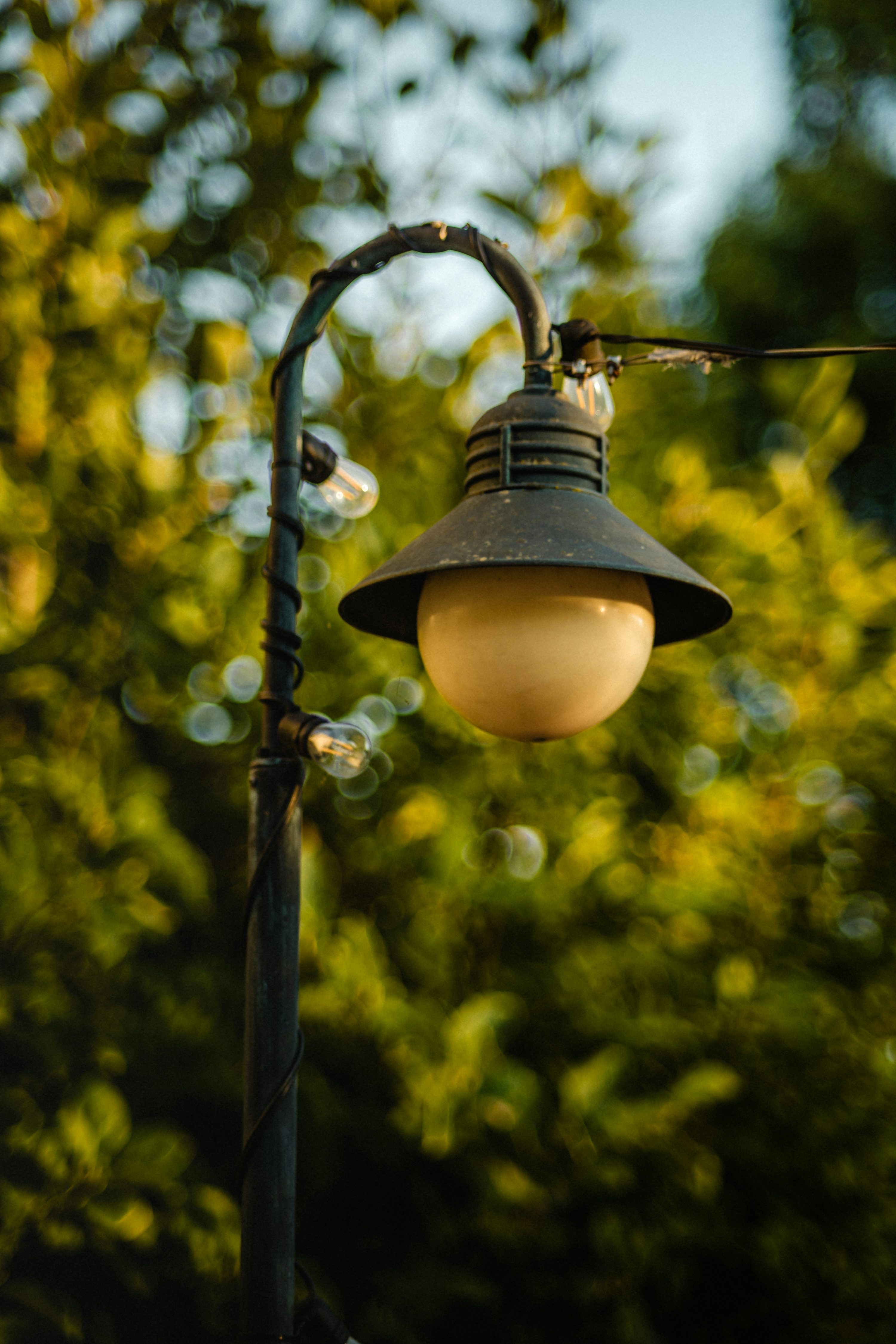 3000x4500 A lamp post with a light hanging off of it's side photo