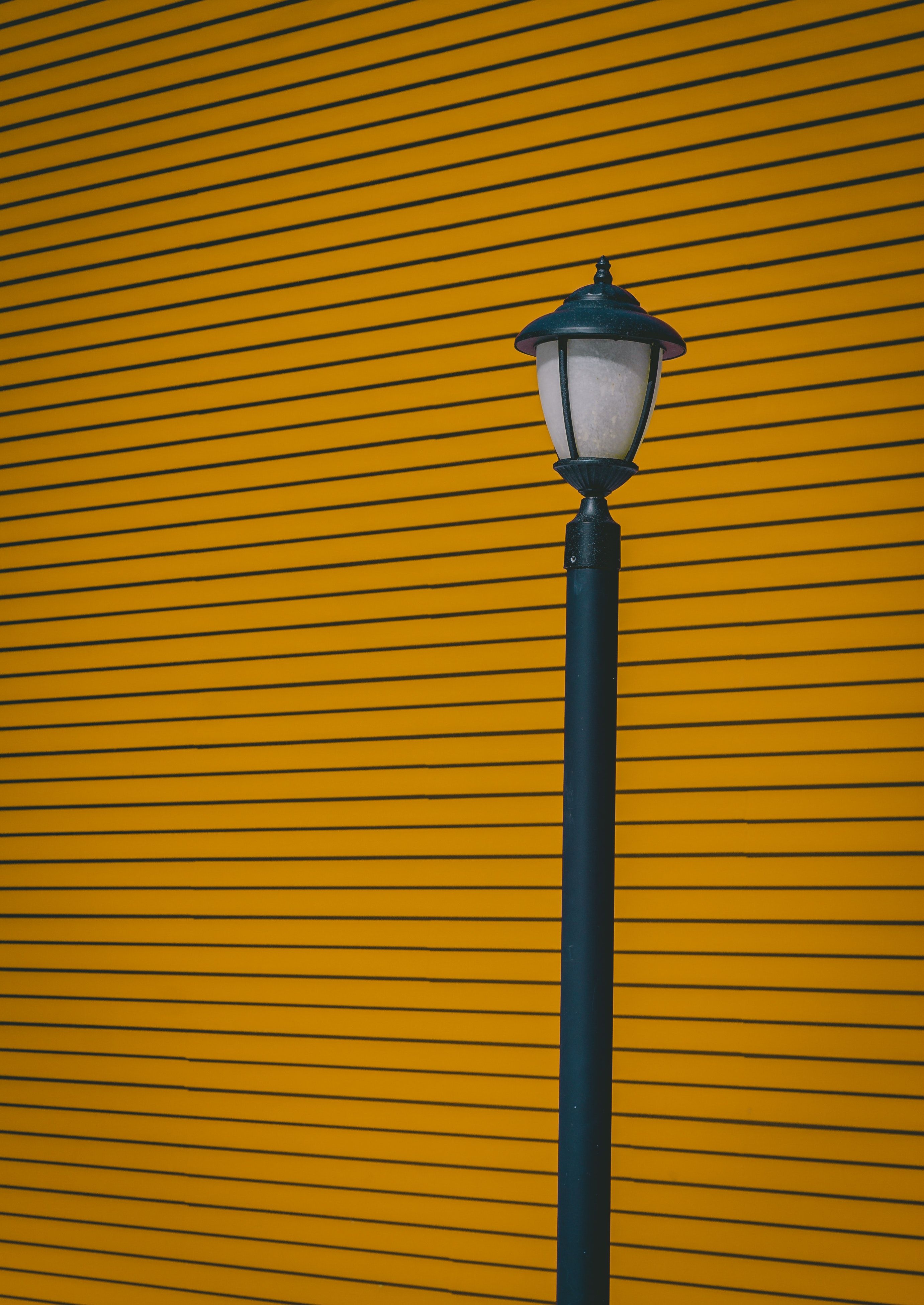 2762x3901 Download wallpaper 2762x3901 lamp post, wall, pillar, stripes, minimalism HD background