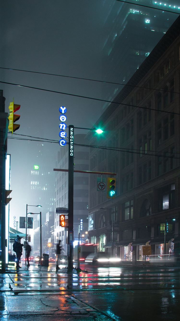 750x1334 people standing near lamp post and building iPhone 8 Wallpaper Free Download