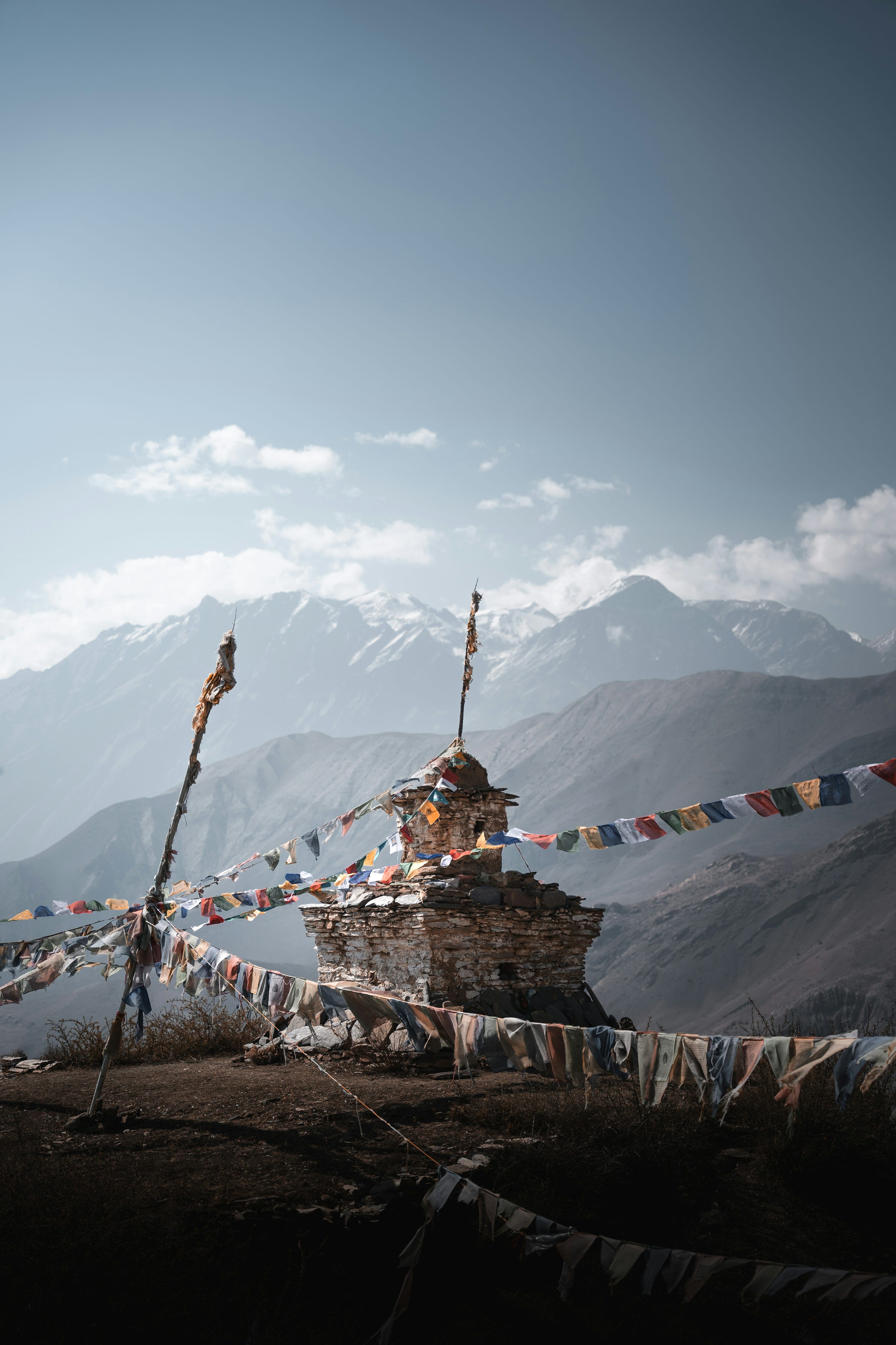 3000x4500 A small building with a lot of flags on top of it photo