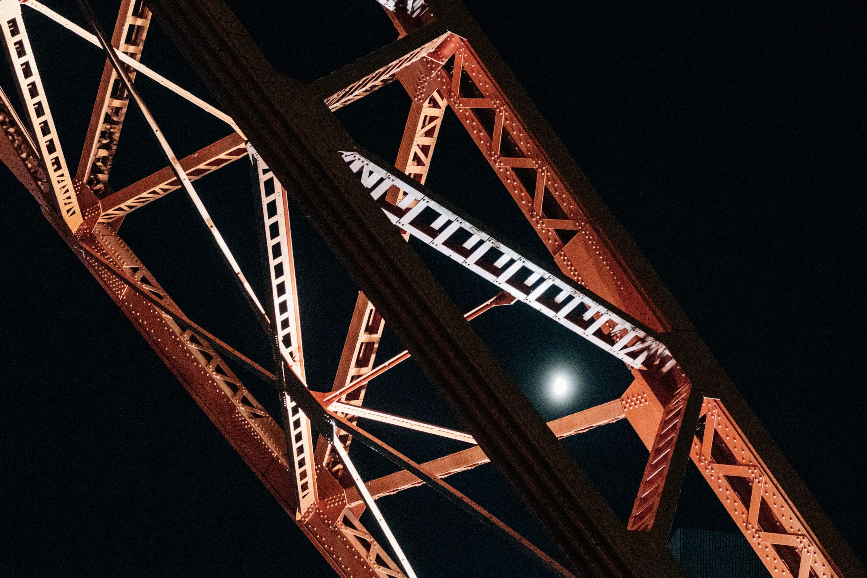 3000x2000 Close Up Of A Red Metal Bridge Structure At Night. Photo