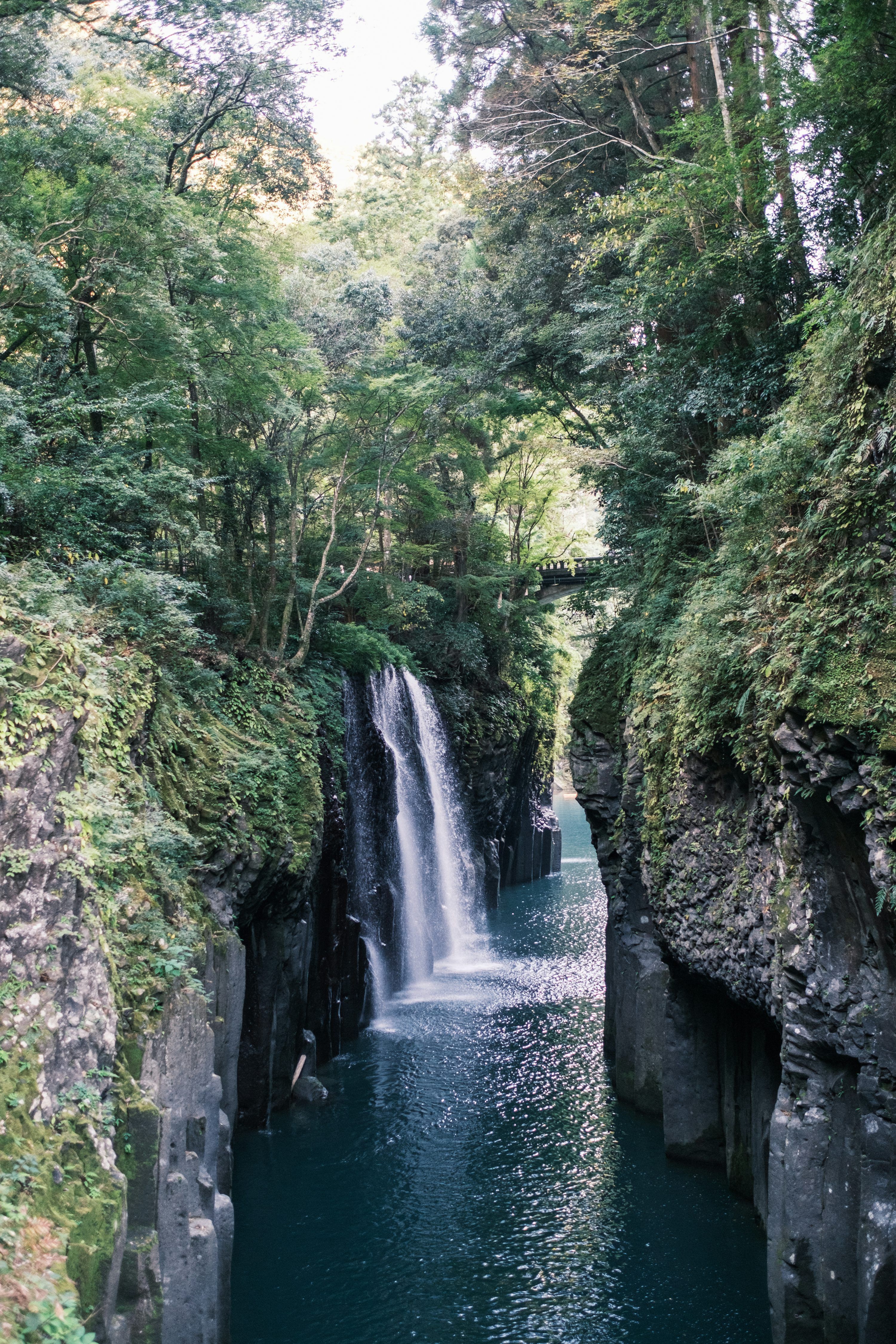 3000x4500 A waterfall in the middle of a river surrounded