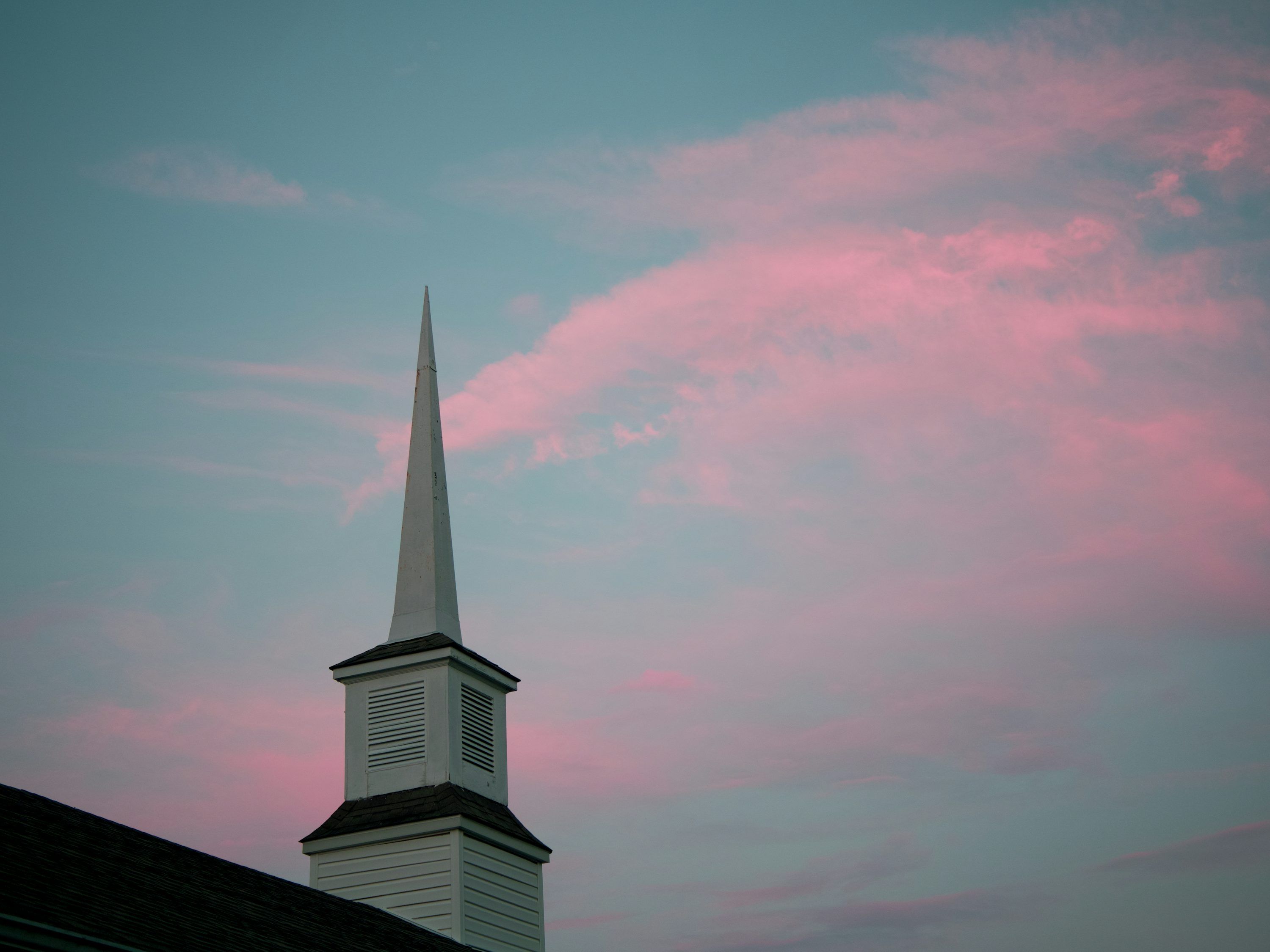 3000x2250 A church steeple with a pink sky in the background photo