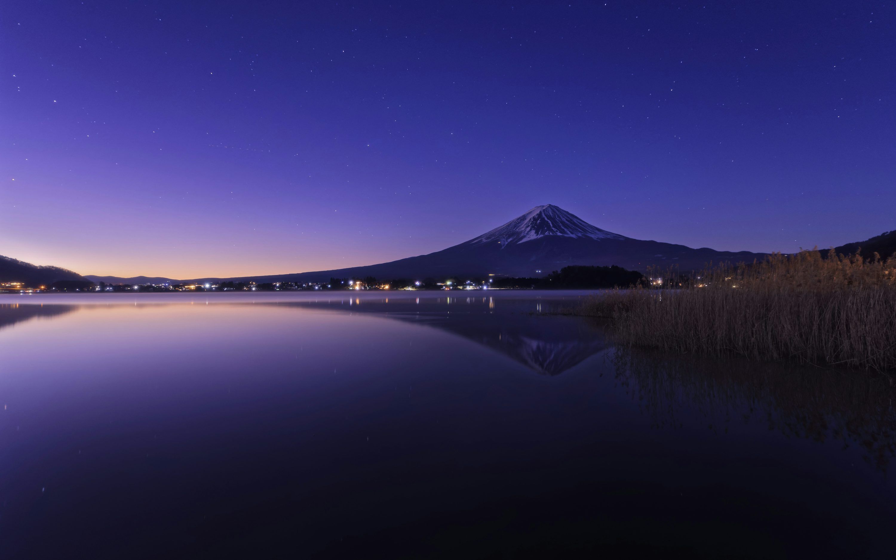3000x1875 A night scene of a lake with a mountain in the background photo