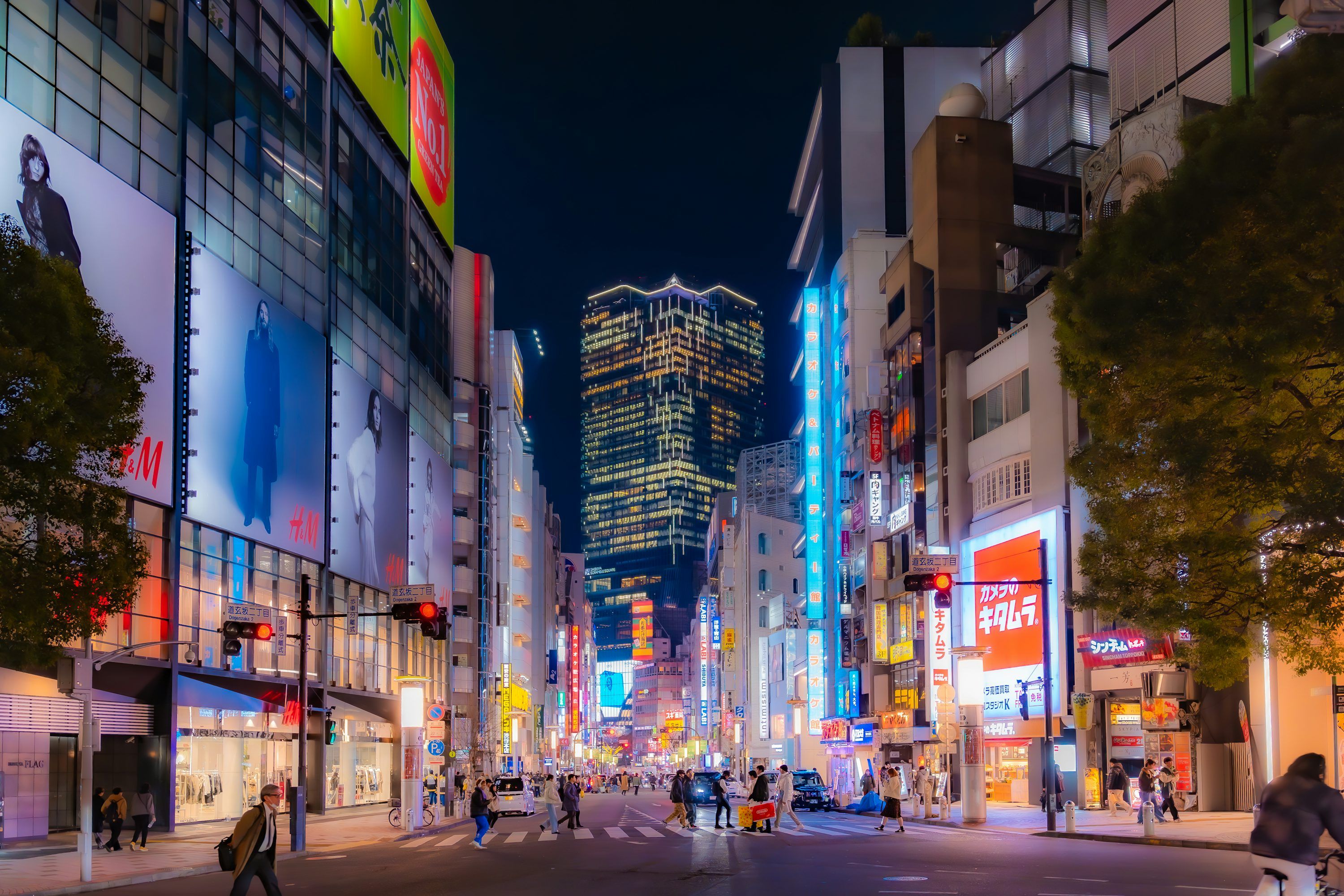 3000x2000 Nighttime view of a bustling city street in japan. photo