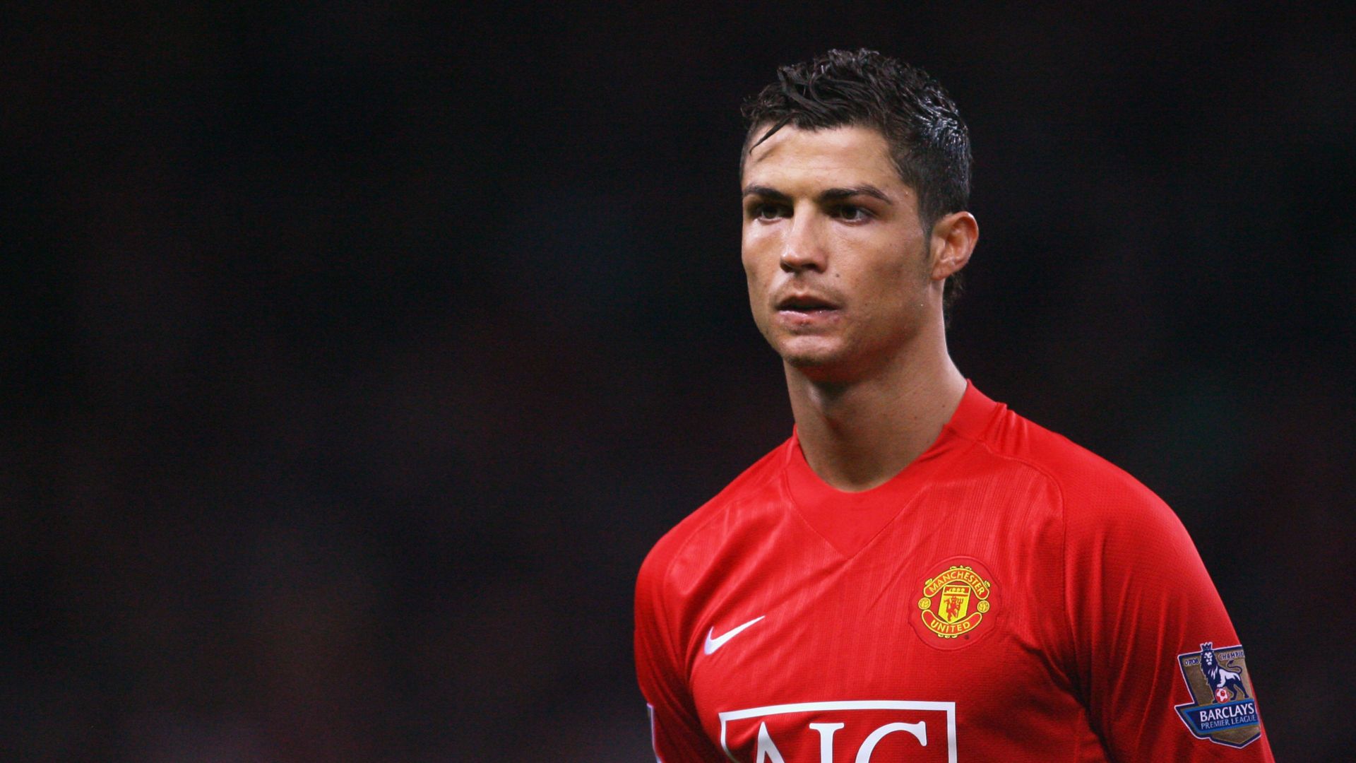 1920x1080 Cristiano Ronaldo Is Wearing Red Sports Dress Standing In Black Background HD Ronaldo Wallpaper