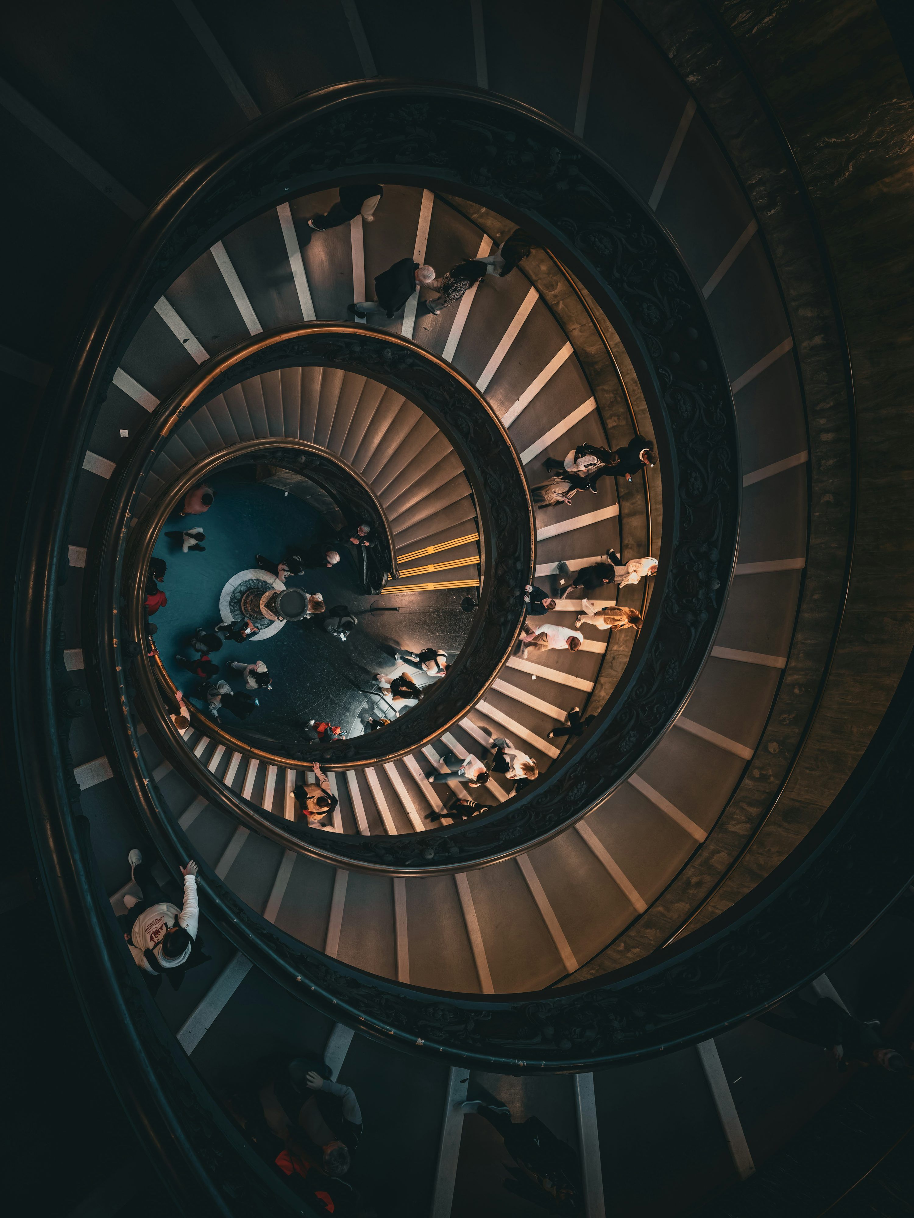 3000x4000 People walk on a beautiful, spiral staircase. photo