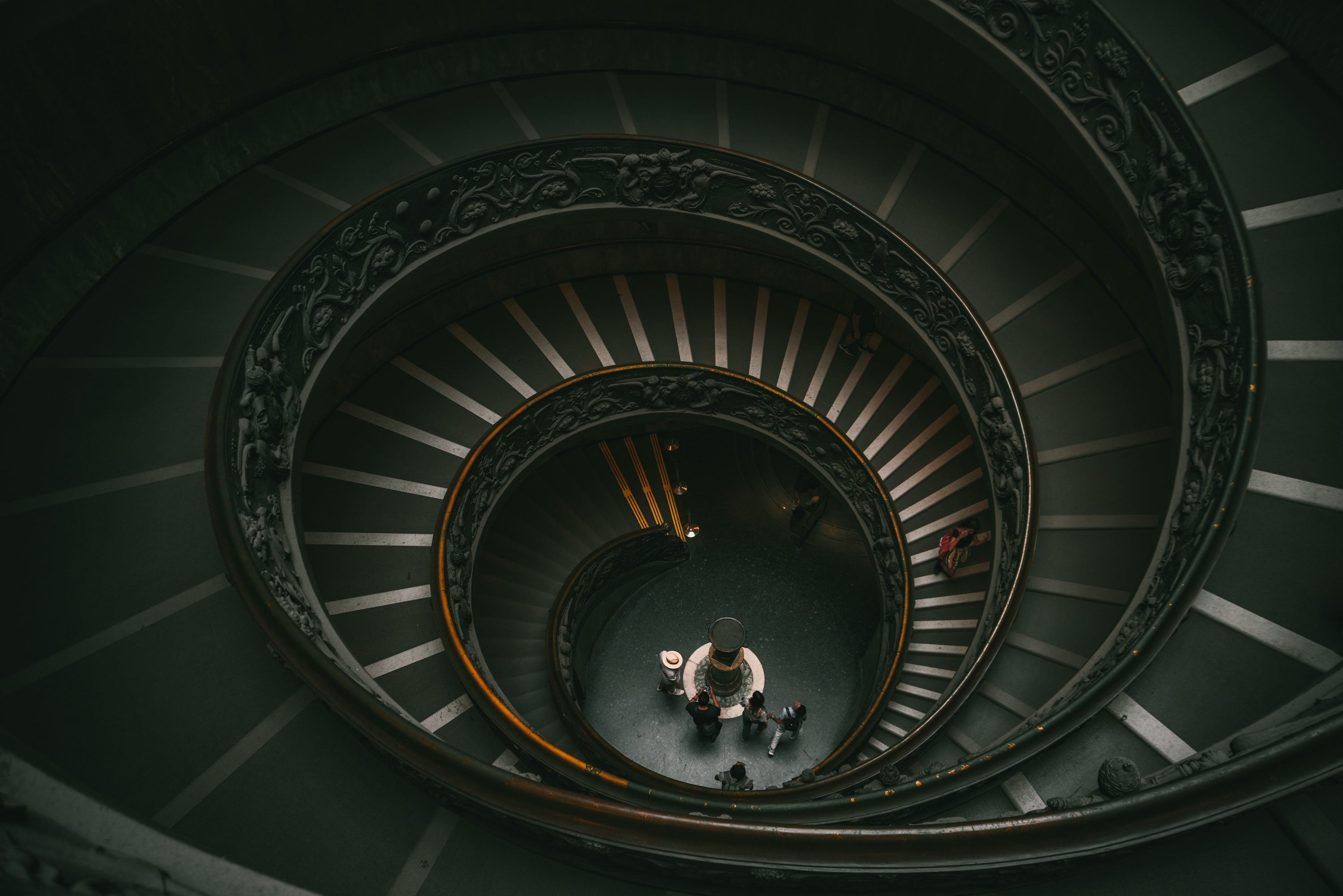 3000x2002 A spiral staircase with people photo
