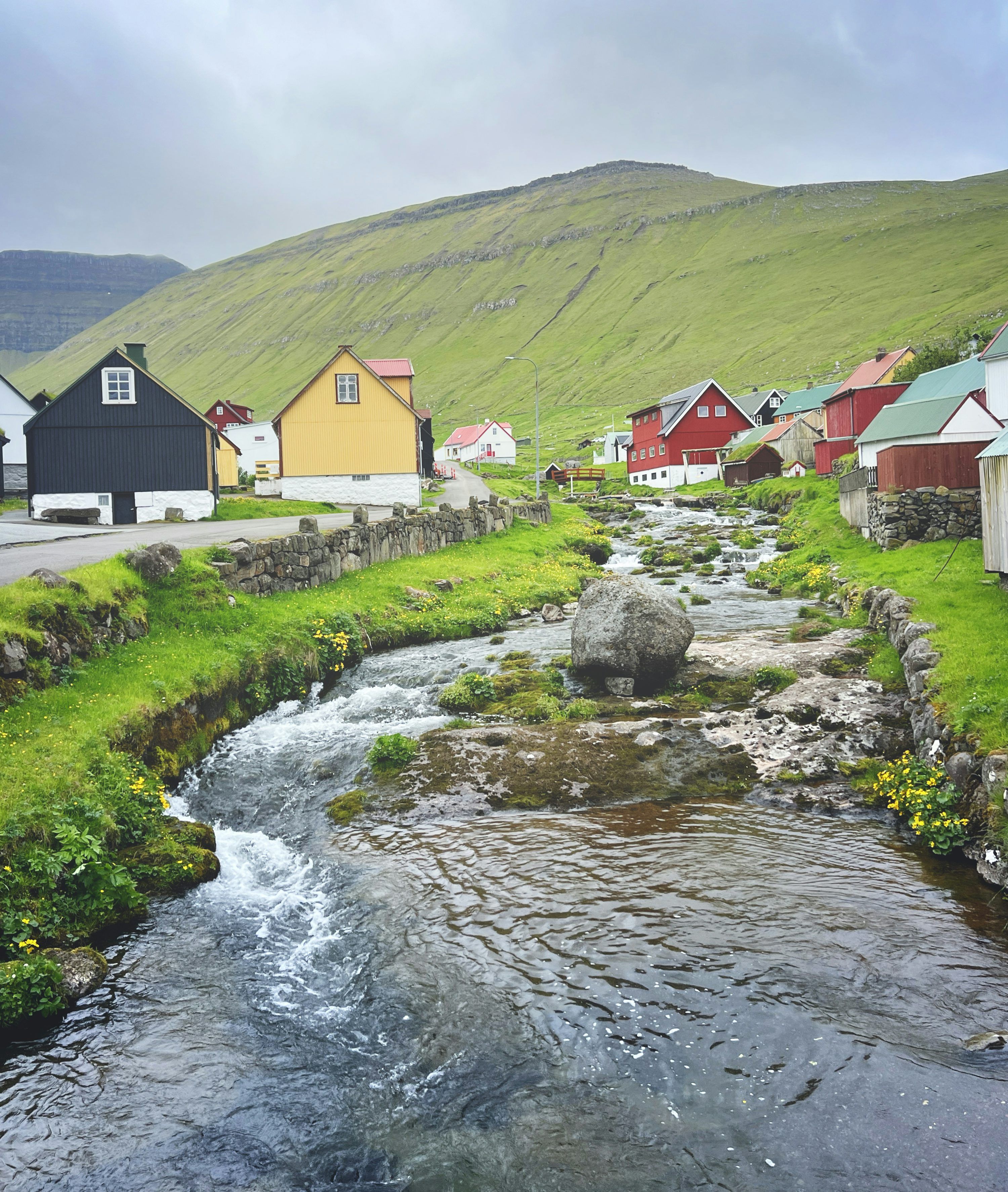 3000x3546 A serene village is next to a flowing stream. photo