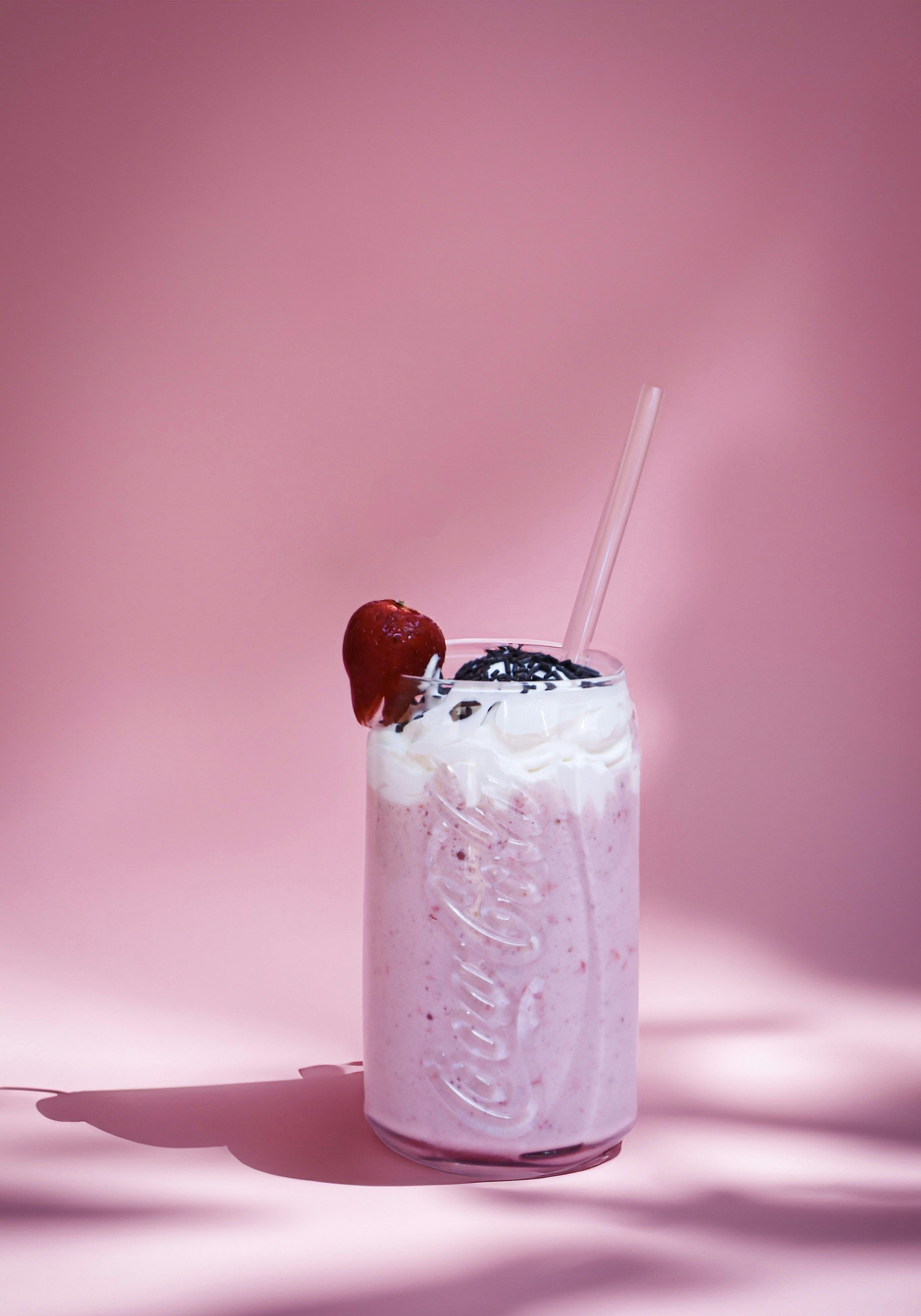 3000x4286 A strawberry milkshake with whipped cream and a straw photo