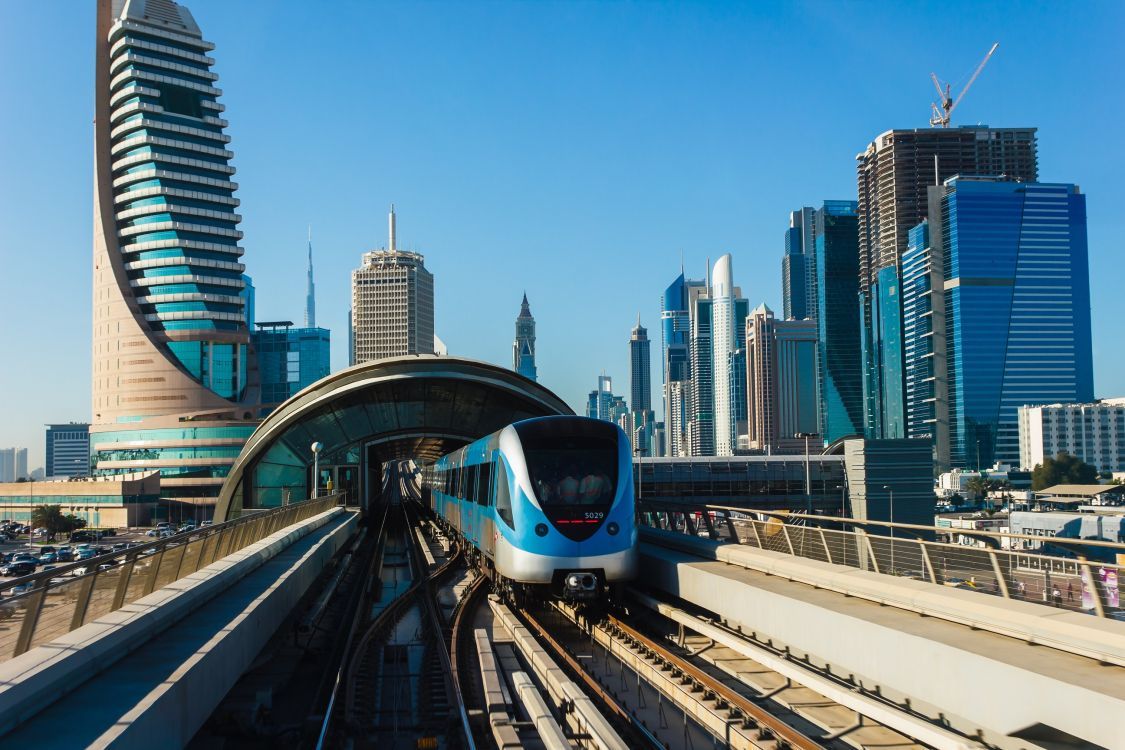 1125x750 Wallpaper White and Blue Train on Rail Tracks Near City Buildings During Daytime, Background Free Image