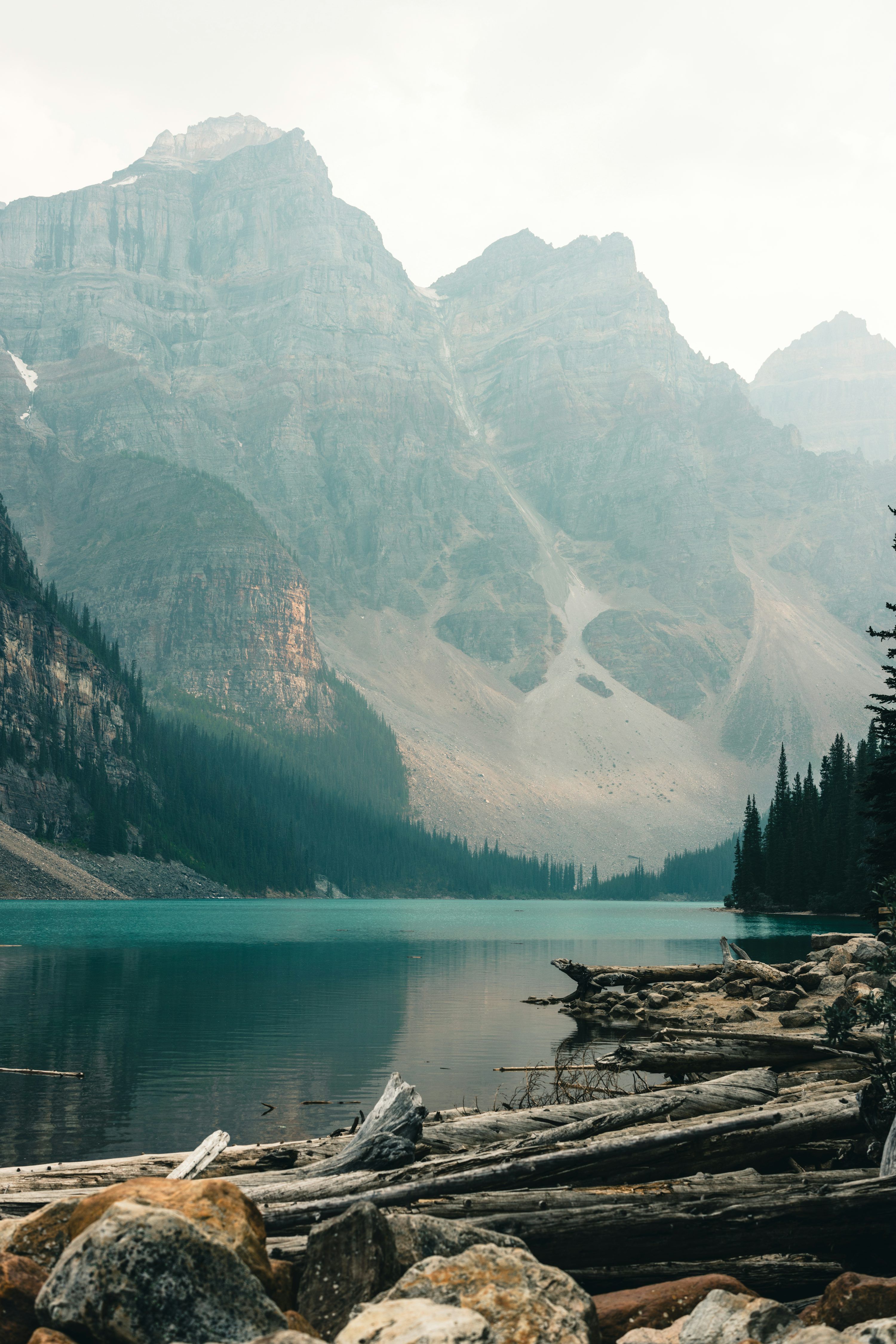 3000x4497 A mountain lake surrounded by trees and rocks photo