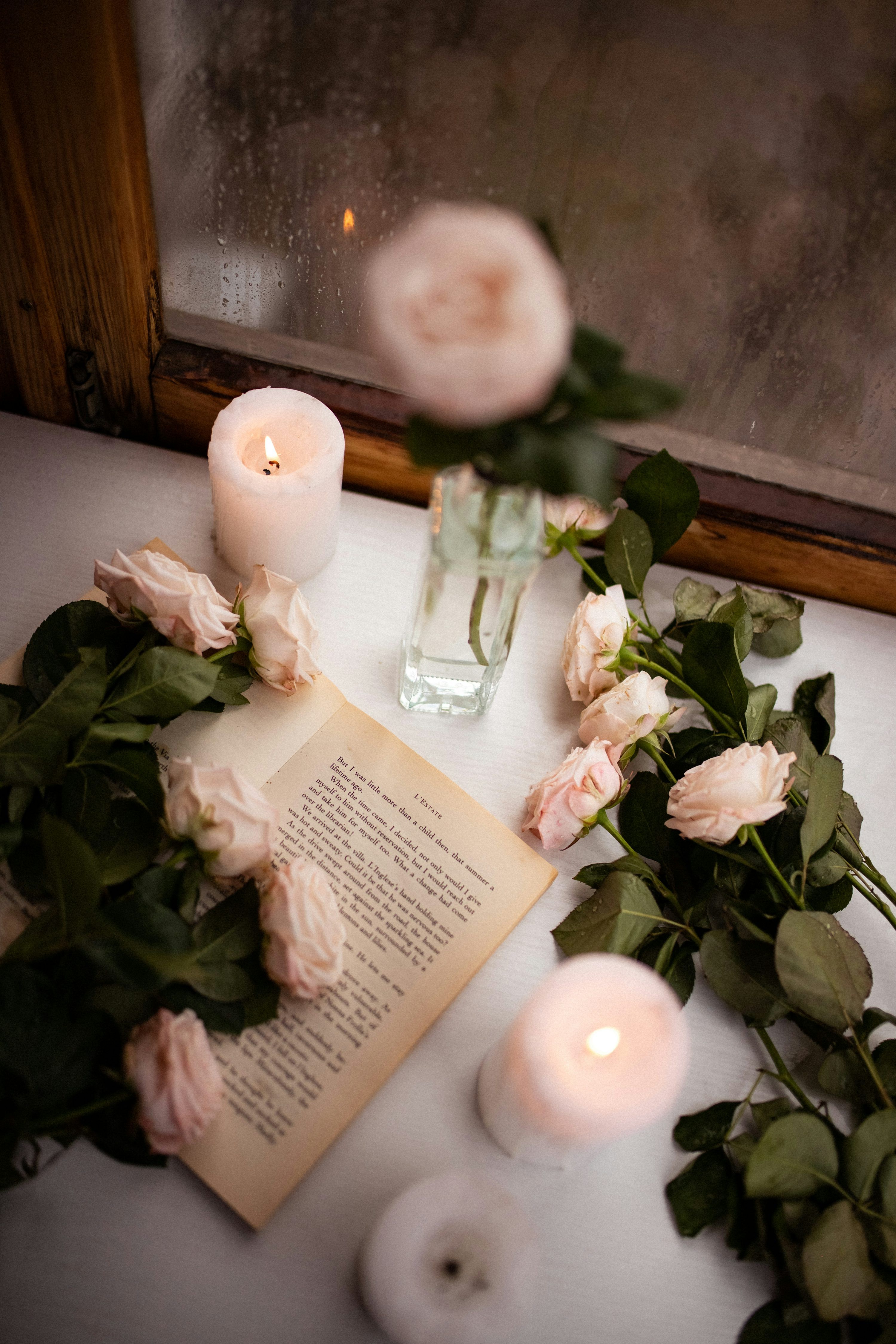 3000x4500 A book and some flowers on a table photo
