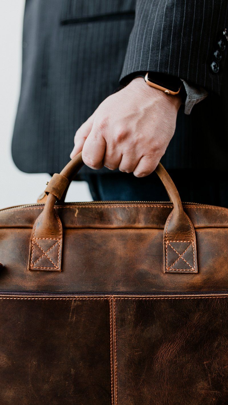 800x1422 Hand Holding Briefcase Image Wallpaper