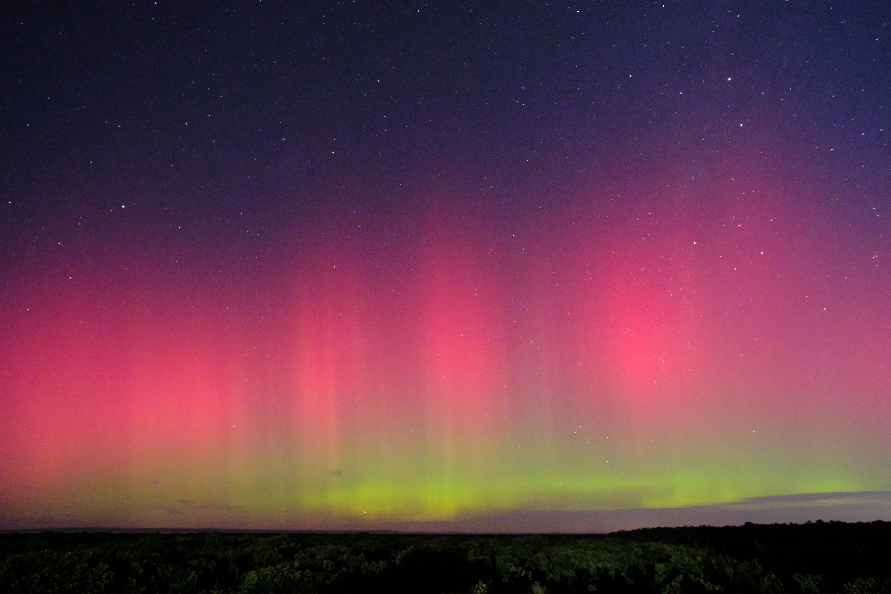 3000x2000 A bright pink and purple aurora bore in the night sky photo