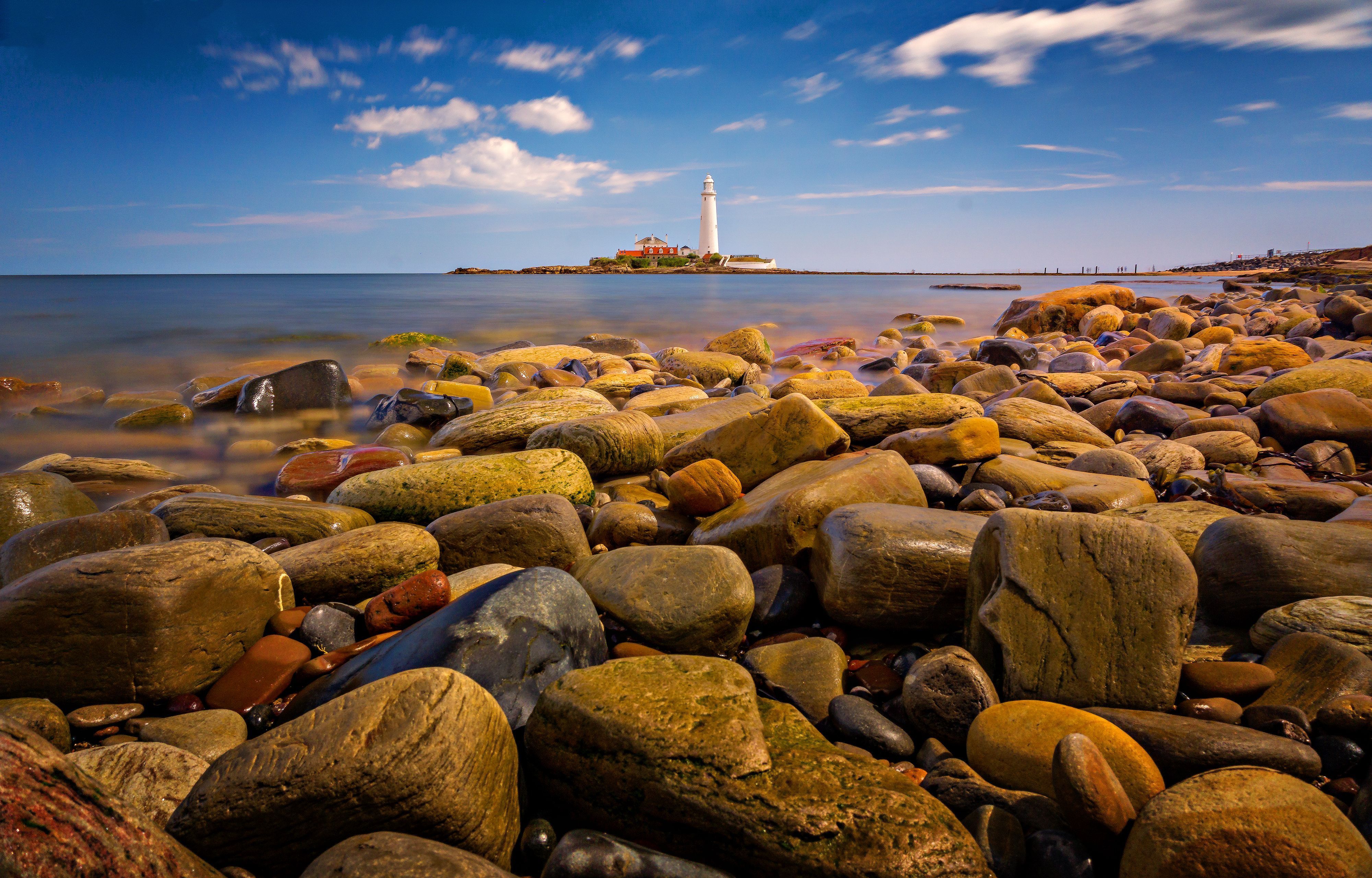 4000x2560 Stones on Shore against St. Mary Lighthouse · Free