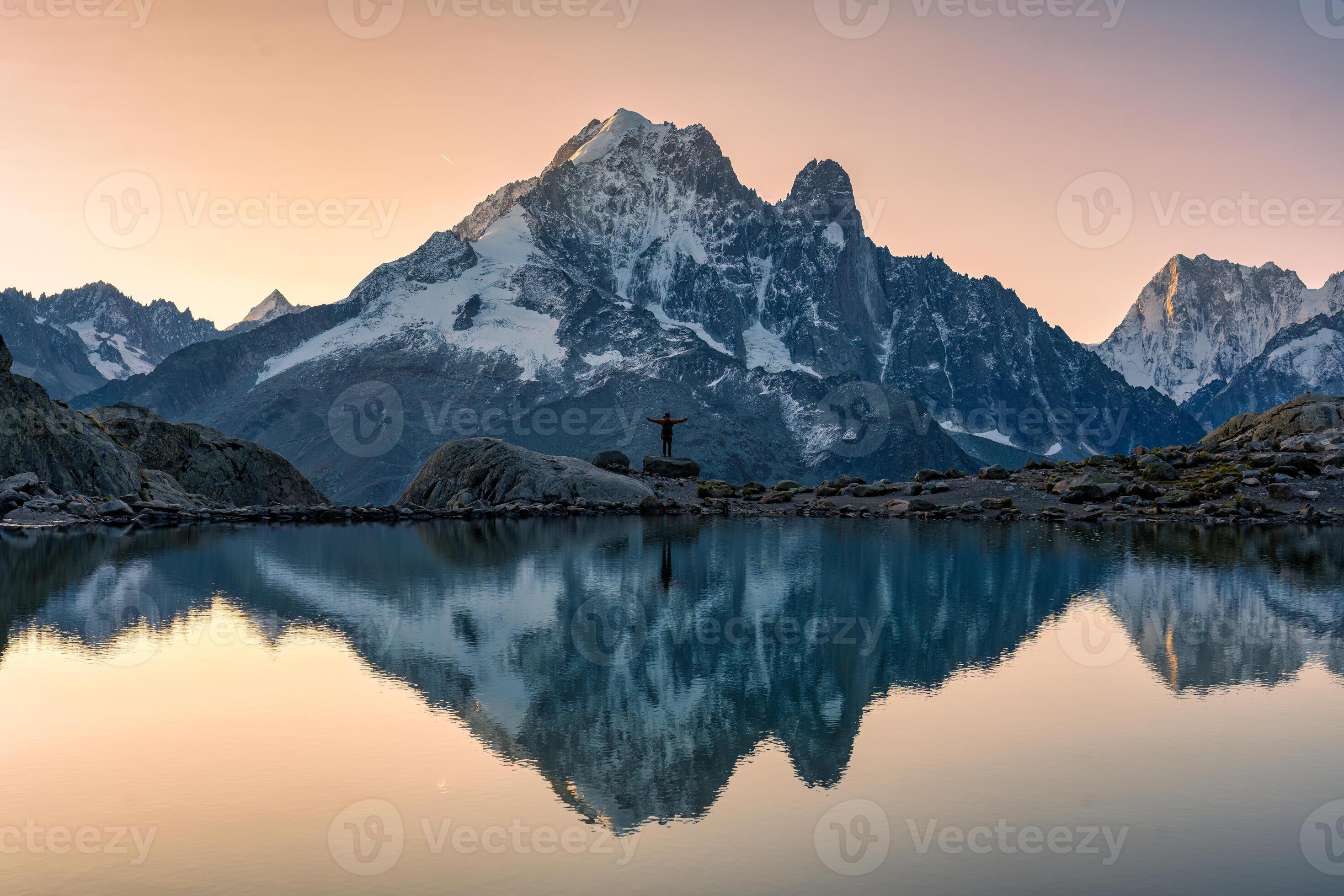 2940x1960 French alps landscape of Lac Blanc with Mont Blanc massif with male traveler reflected on the lake at Chamonix, France