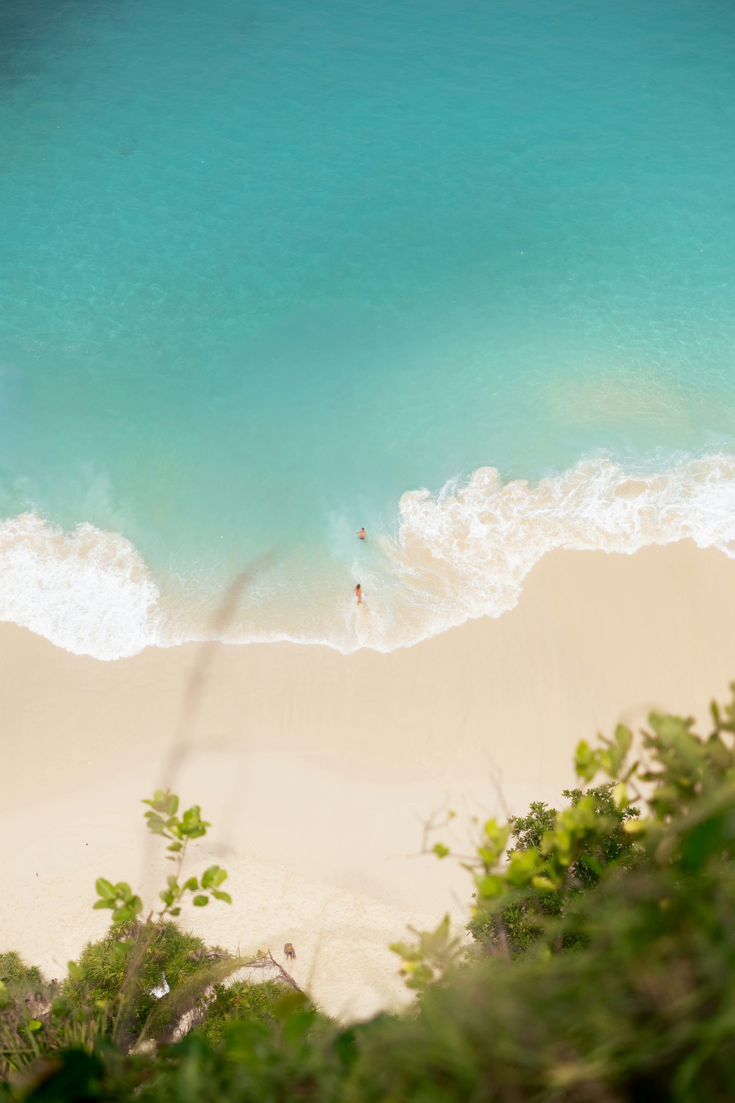 3000x4500 A view of a beach from above looking down at the water photo