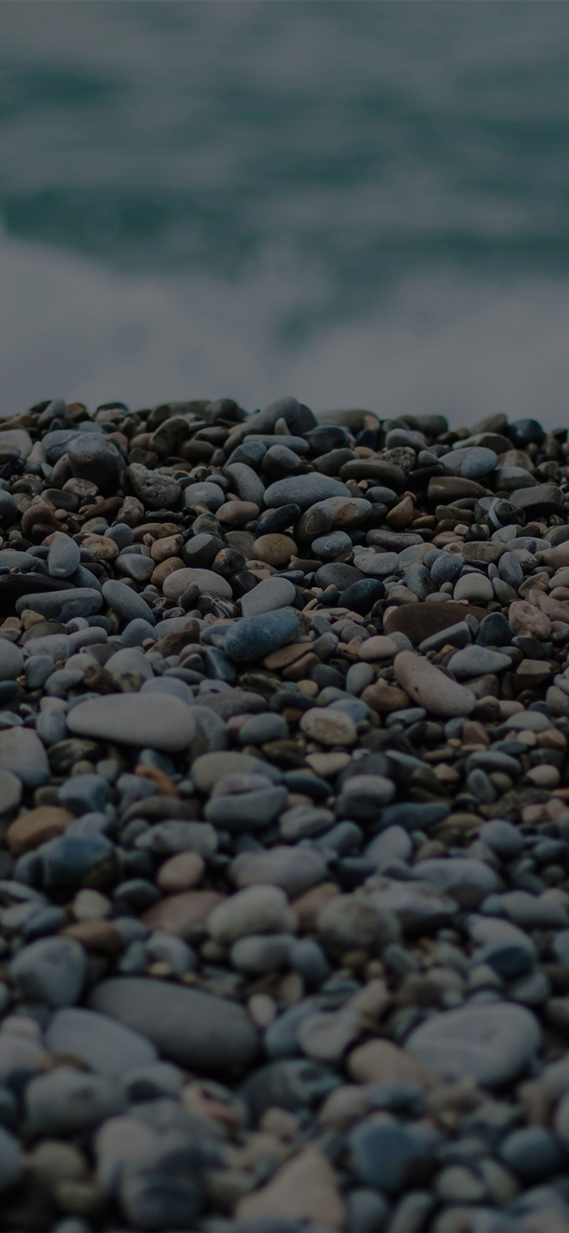 1125x2436 Beach stones sea iPhone X Wallpaper Free Download