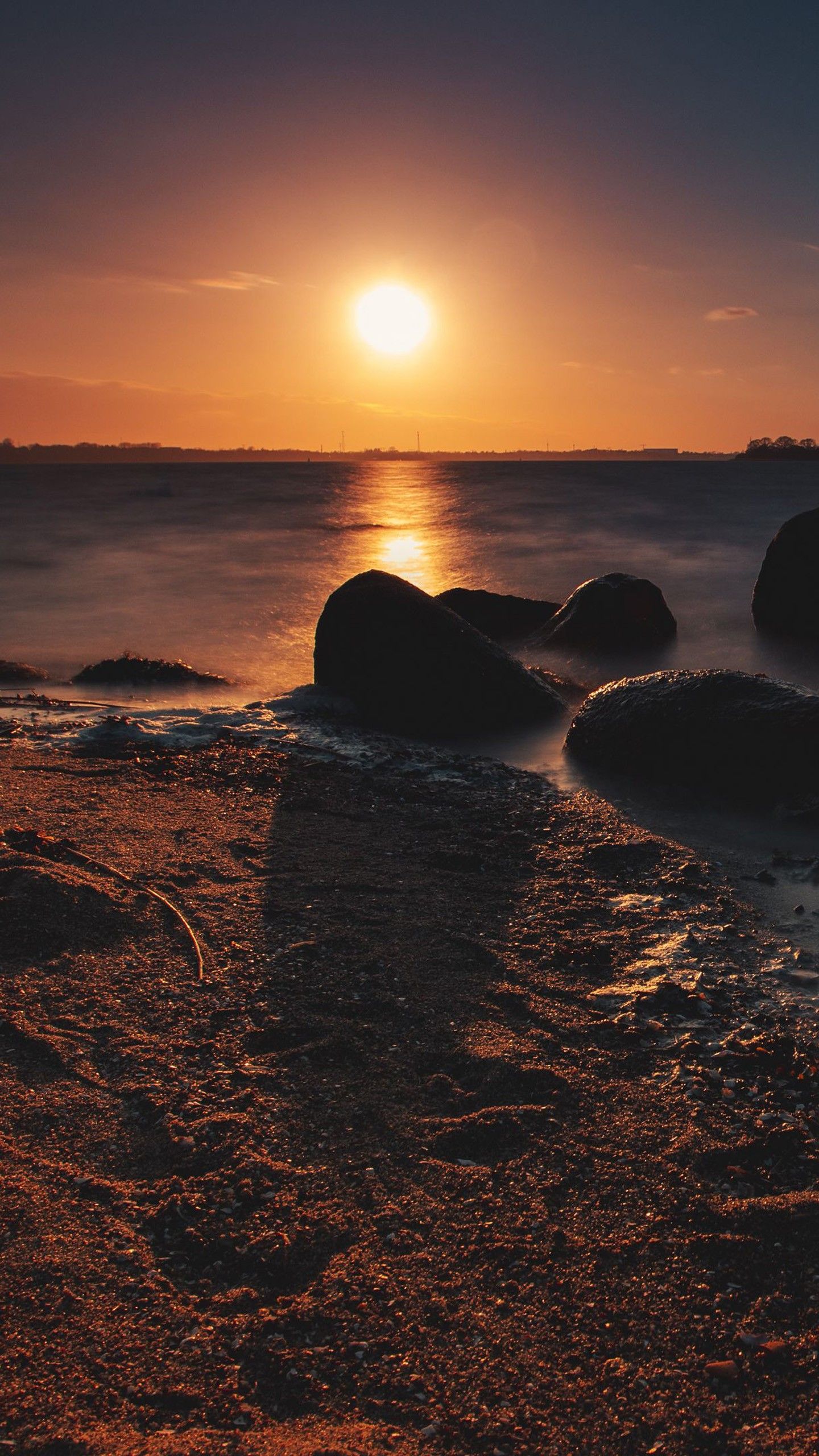 1440x2560 Sea Shore During Sunset Ocean Sand Stones On Water 4K HD Nature Wallpaper