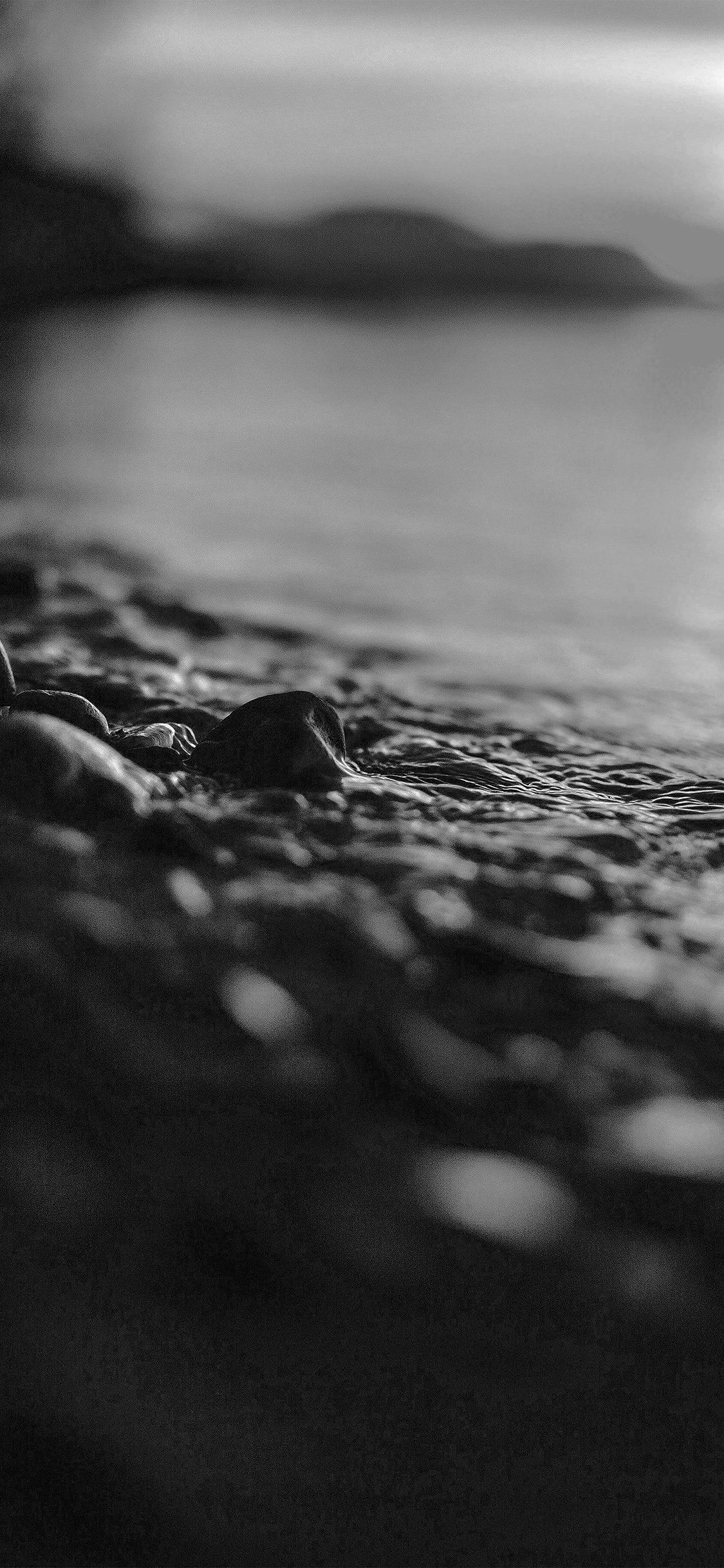 1125x2436 Sea Stone Lake Rock Bokeh Night Wave Bw Dark iPhone Wallpaper