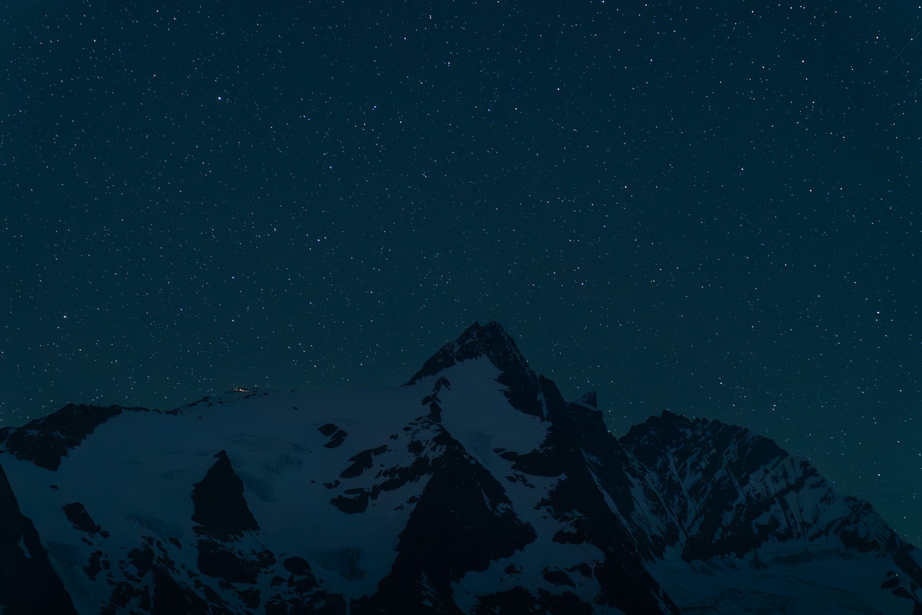 3000x2001 Snowy mountain peak under a starry night sky photo