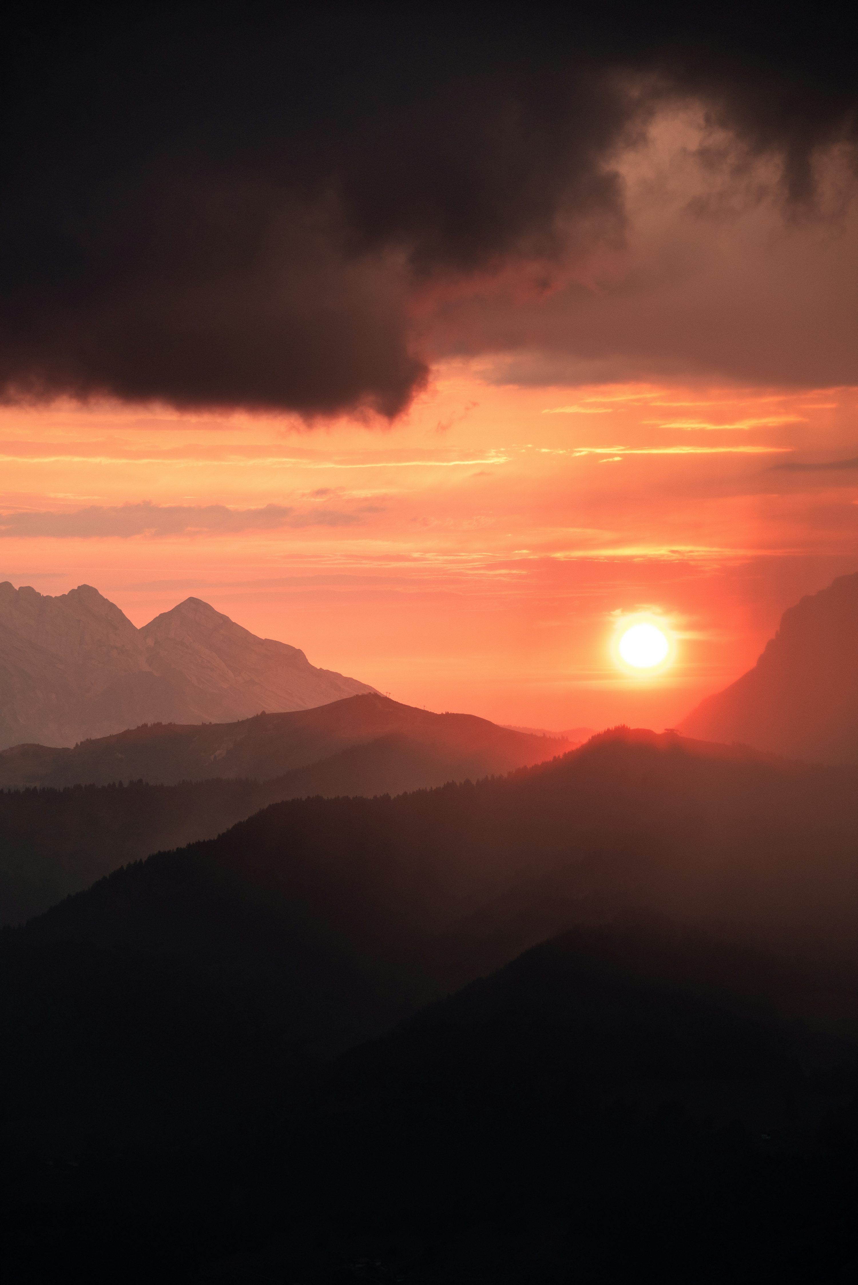 3000x4494 A glowing sunset paints mountains with warm hues. photo