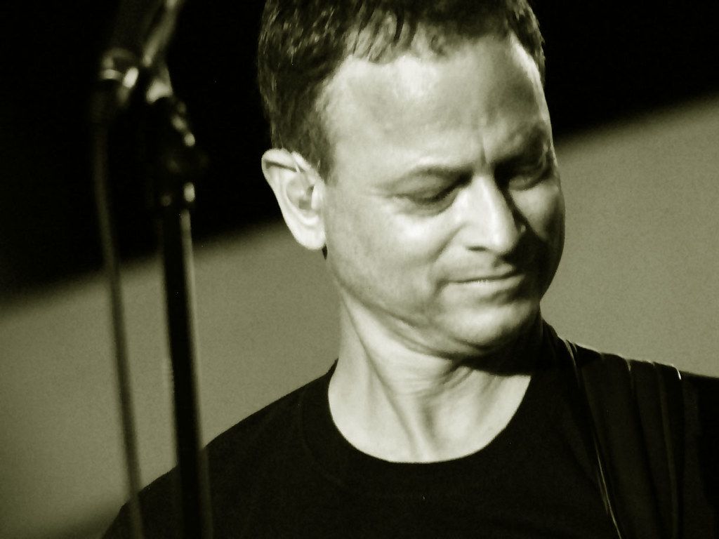 1024x768 gary sinise. playing base for his LT DAN band as a USO conc